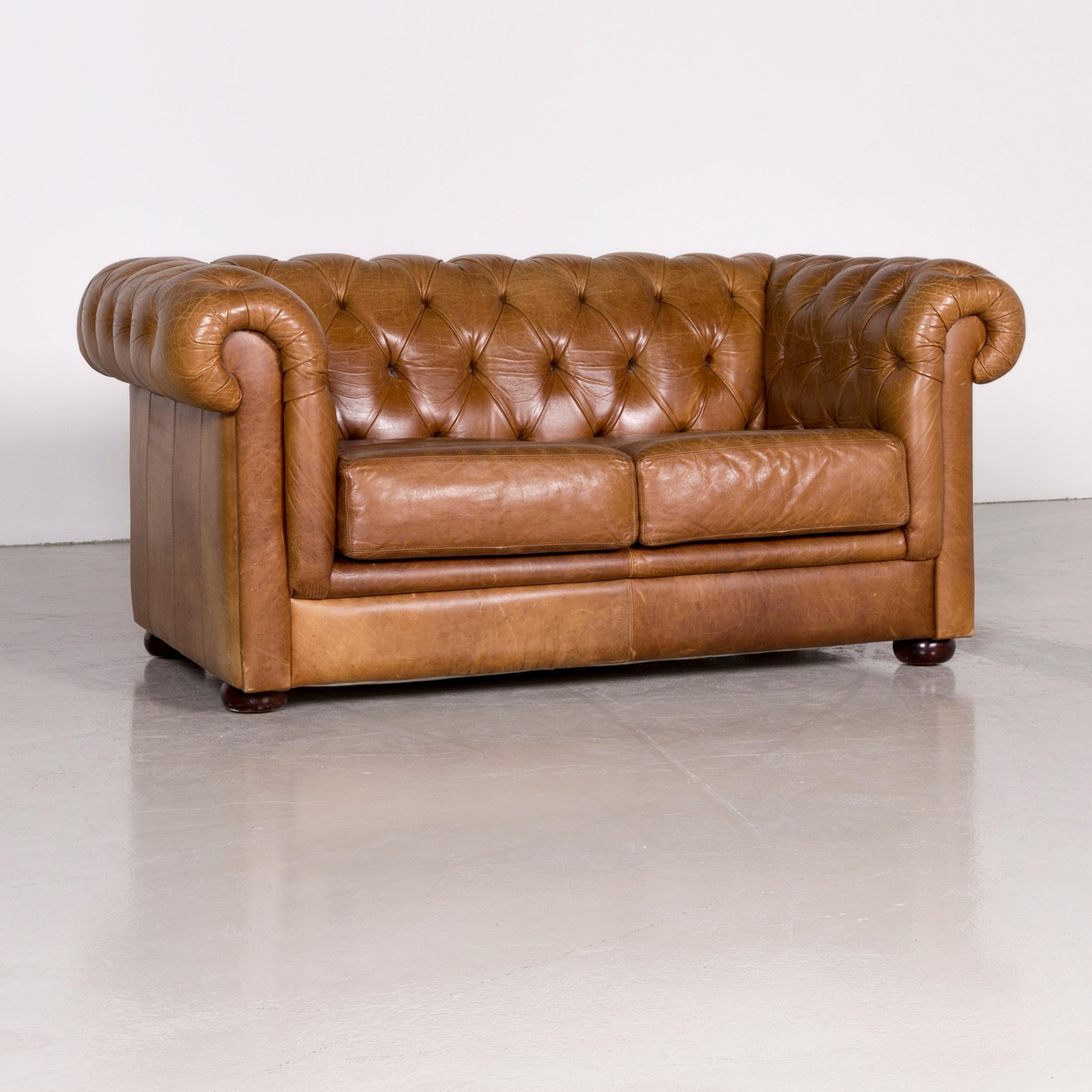 We bring to you a Chesterfield leather sofa brown vintage two-seat couch.