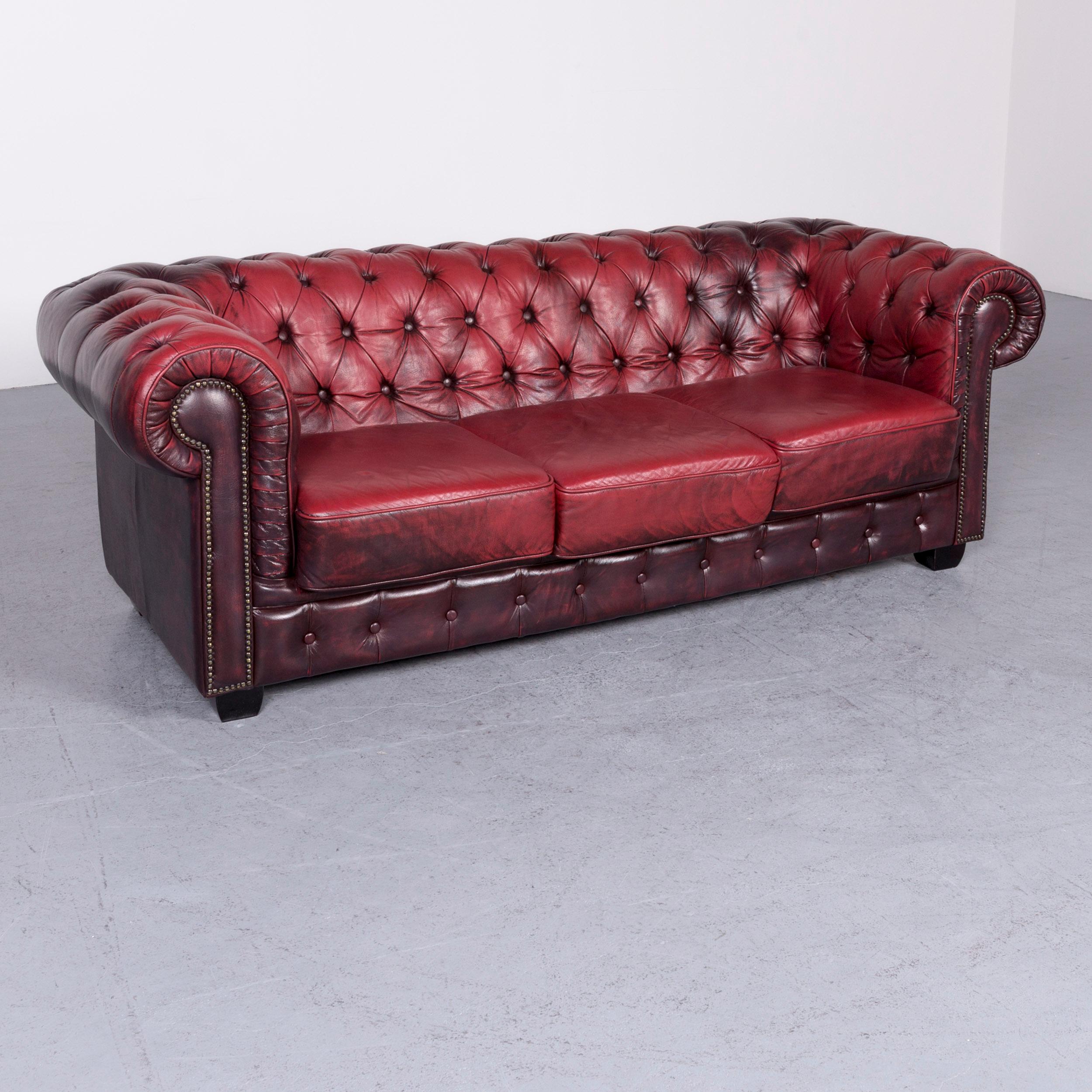We bring to you a Chesterfield leather sofa red three-seat vintage couch.





























