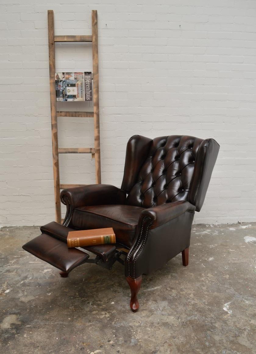 Unique for it's time. This 100% kept original Chesterfield Lazyboy/ relaxing chair.
This Chesterfield reclining chair has Queen Anne front legs and straight legs in the back to give it a hard solid base. Frame is perfect and comfort is