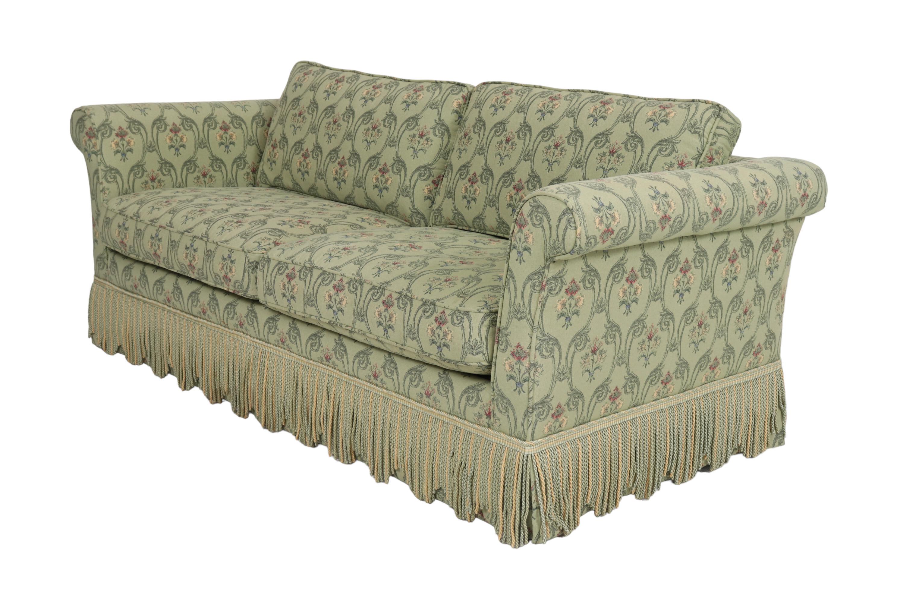 A Chesterfield style “Convertible Fashion Sofa” made by Stearns & Foster. A three-seat sleeper sofa custom upholstered by Alliance Upholstery of Springfield, Massachusetts in Robert Allen’s Camay basketweave fabric in green. Trimmed with a scalloped