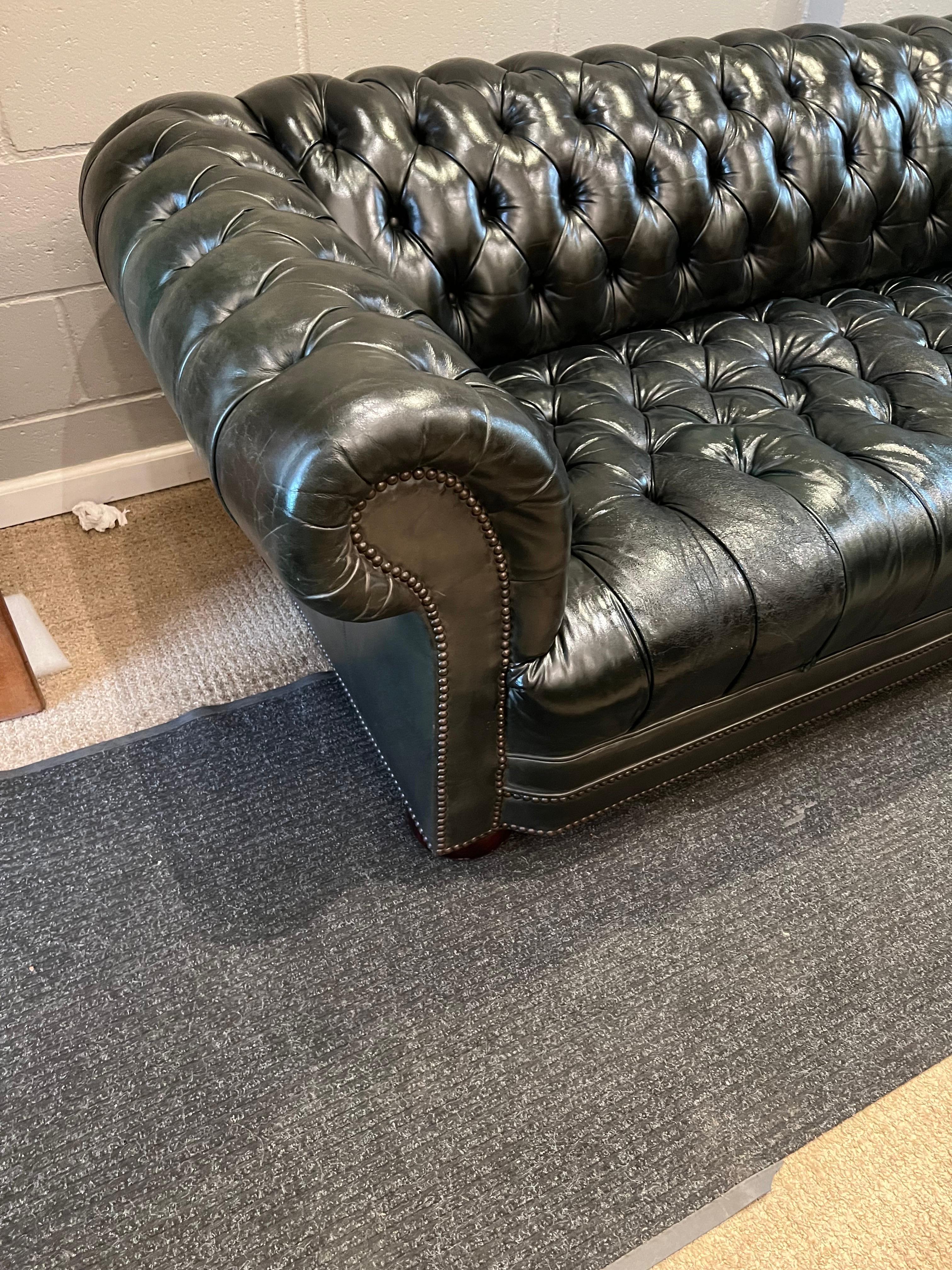 green tufted leather sofa