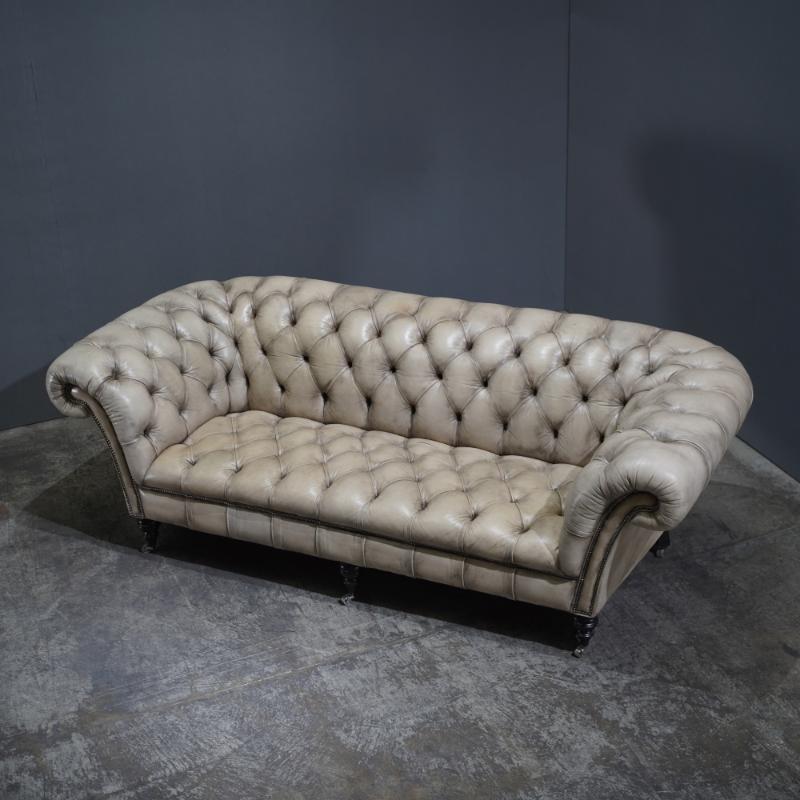 The Chesterfield Sofa by Philip Stanhope from Fleming & Howland is the epitome of classic elegance and timeless design. Handcrafted with meticulous attention to detail, this heirloom piece features the iconic deep button tufting, rolled arms, and