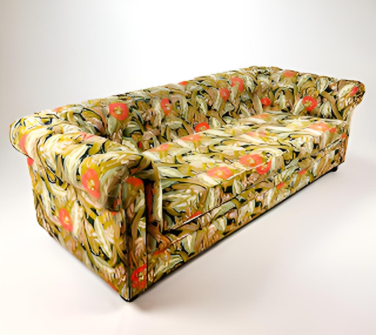 This striking sofa is a bold reinterpretation of a classic Chesterfield silhouette, distinguished by its deeply tufted back, low rolled arms, and generous proportions. Upholstered in a richly patterned, multicolored fabric, the piece exudes a