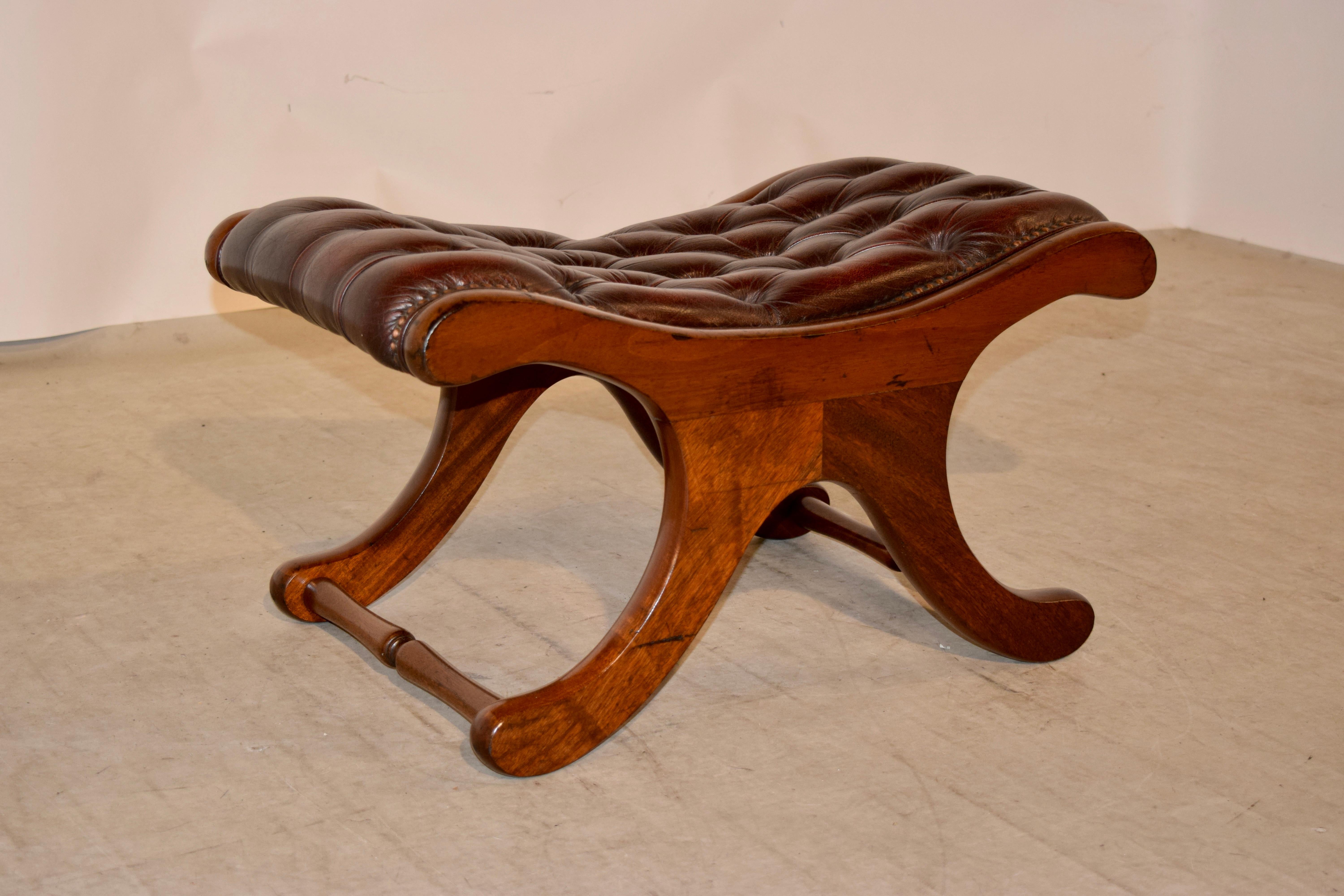English mahogany stool with a Chesterfield upholstered leather top in rich brown with brass tack decoration, circa 1920.
 