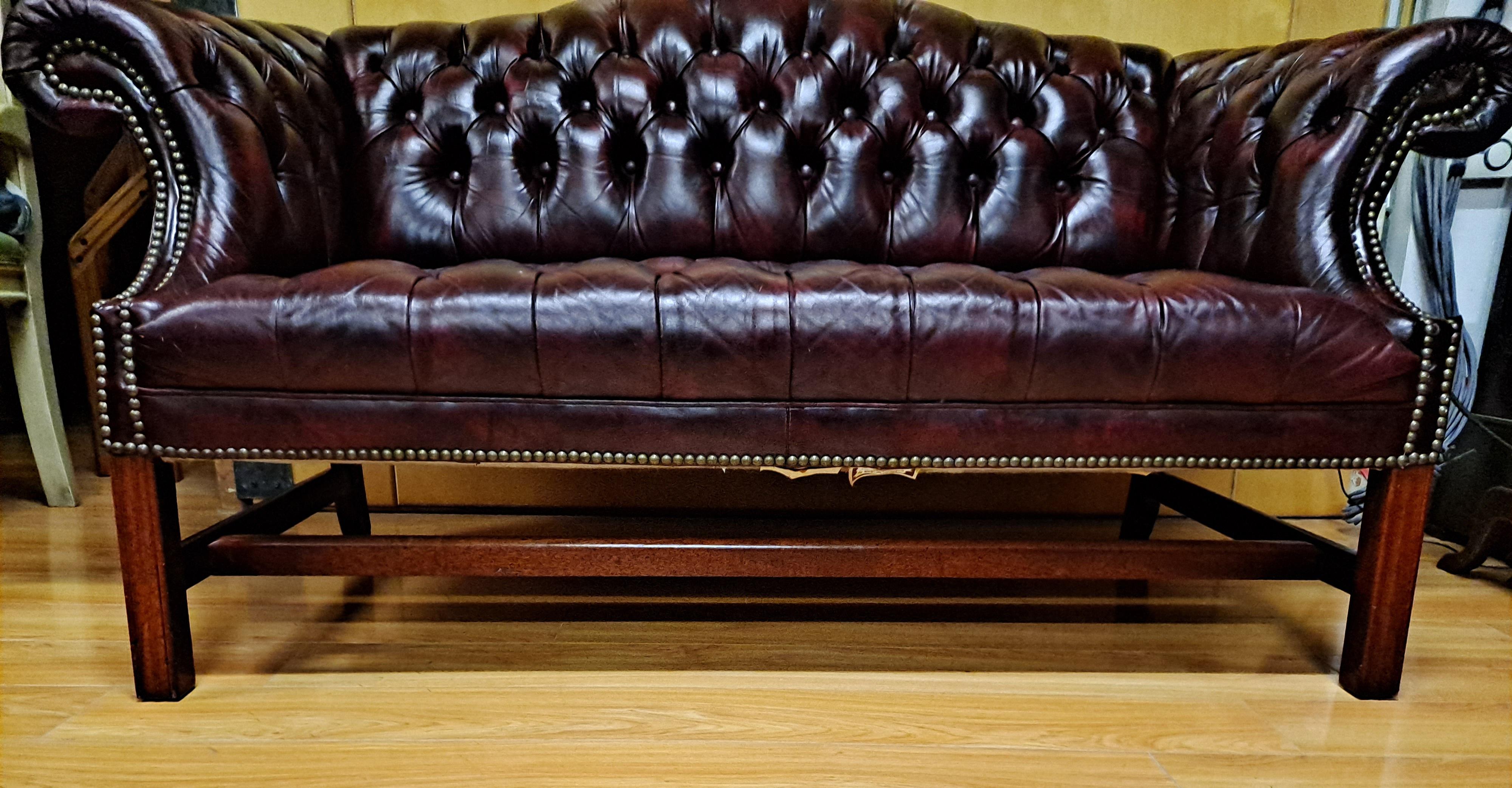Chesterfield Style Burgundy Button Tufted Sofa by Classic Leather, INC  of North Carolina 

Camelback, scrolled Arms and nailhead trim

61