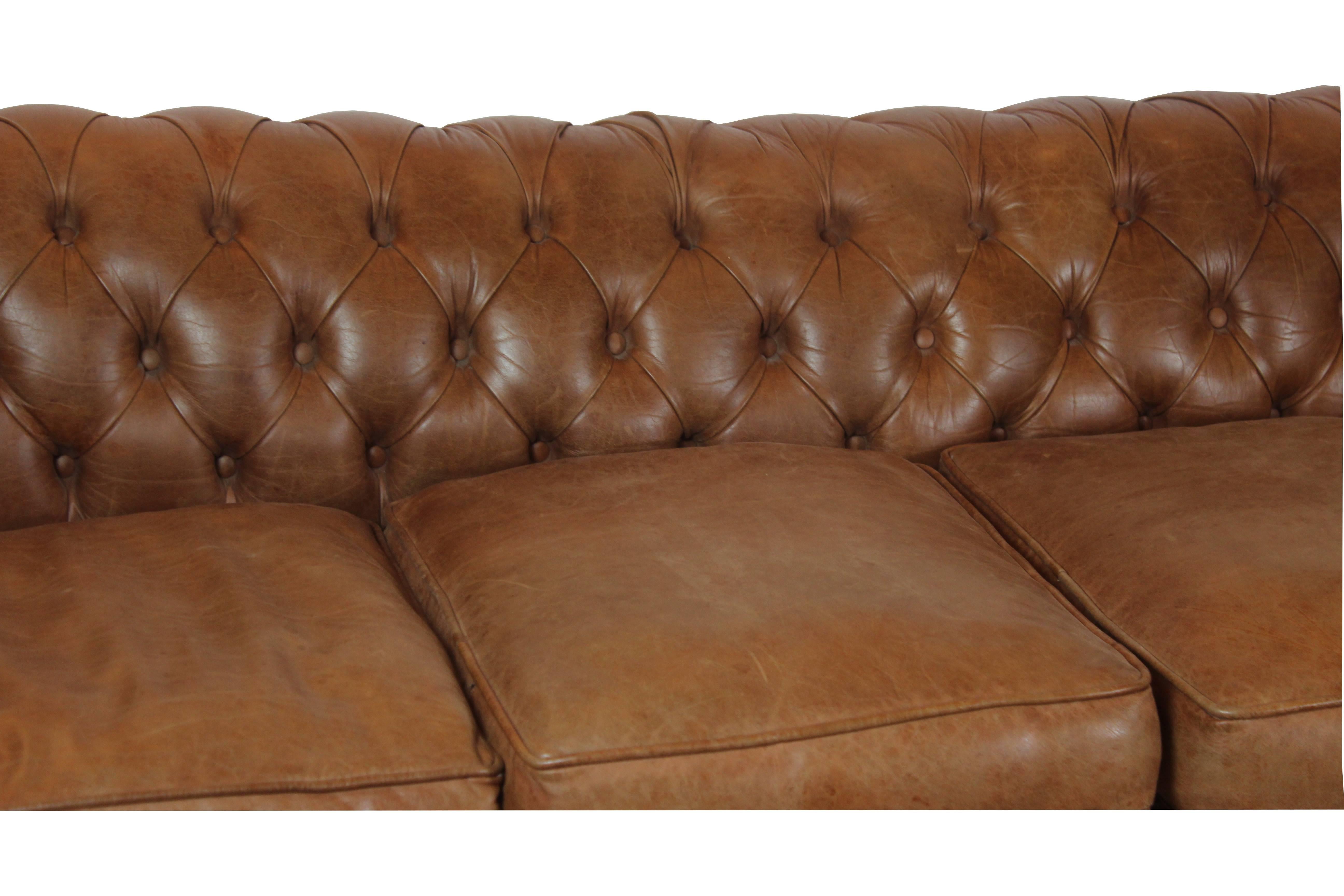 Chesterfield style sofa wonderful quality made with soft leather, four loose cushions and four ball feet.