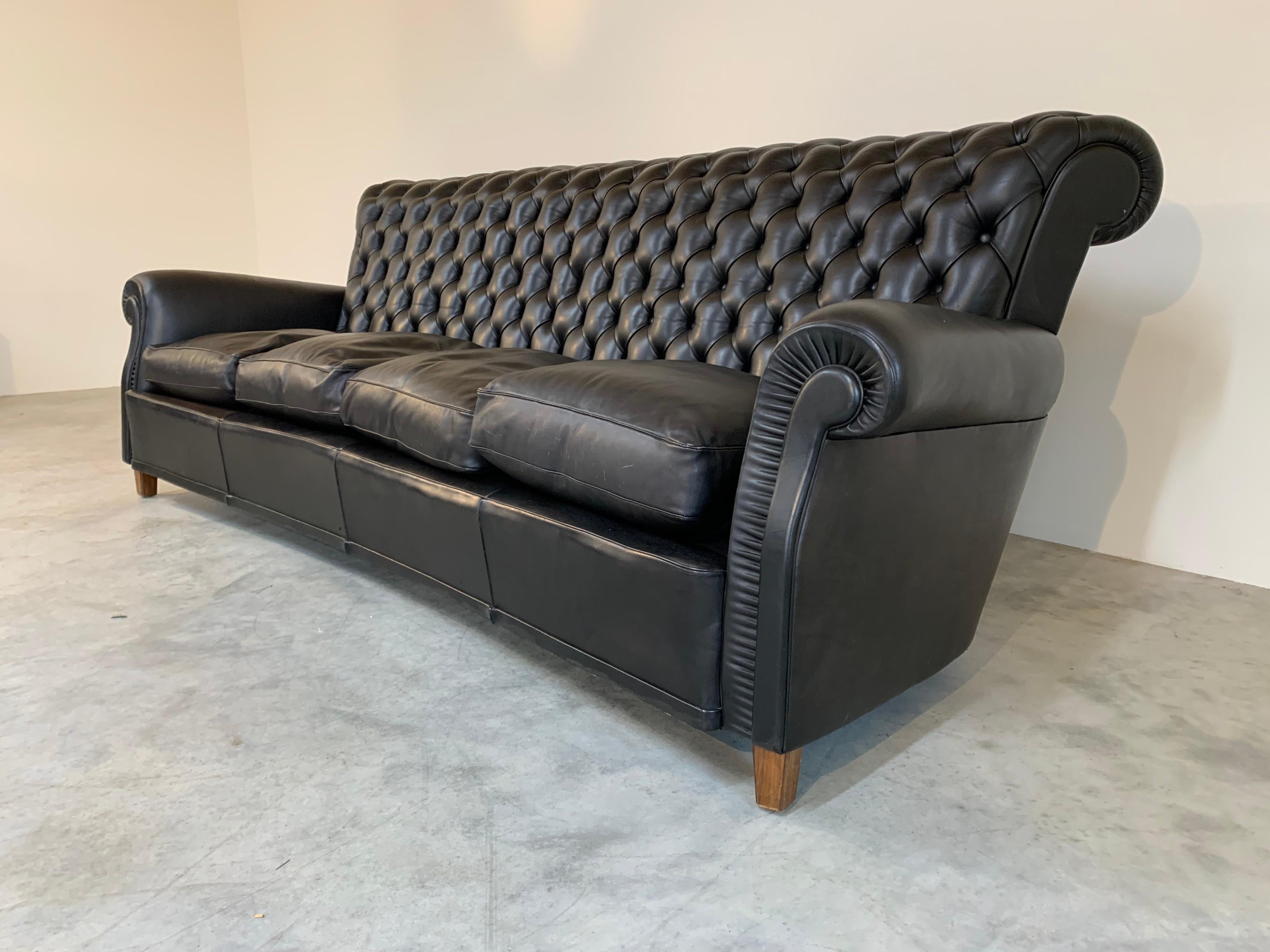 “Bonnie” Sofa by Poltrona Frau. 
 Curved frame having tufted black leather with overstuffed down cushions. -Italy 1967
Imported by the original owner who was a retired professional basketball player from the Italian League. 
 Regularly treated