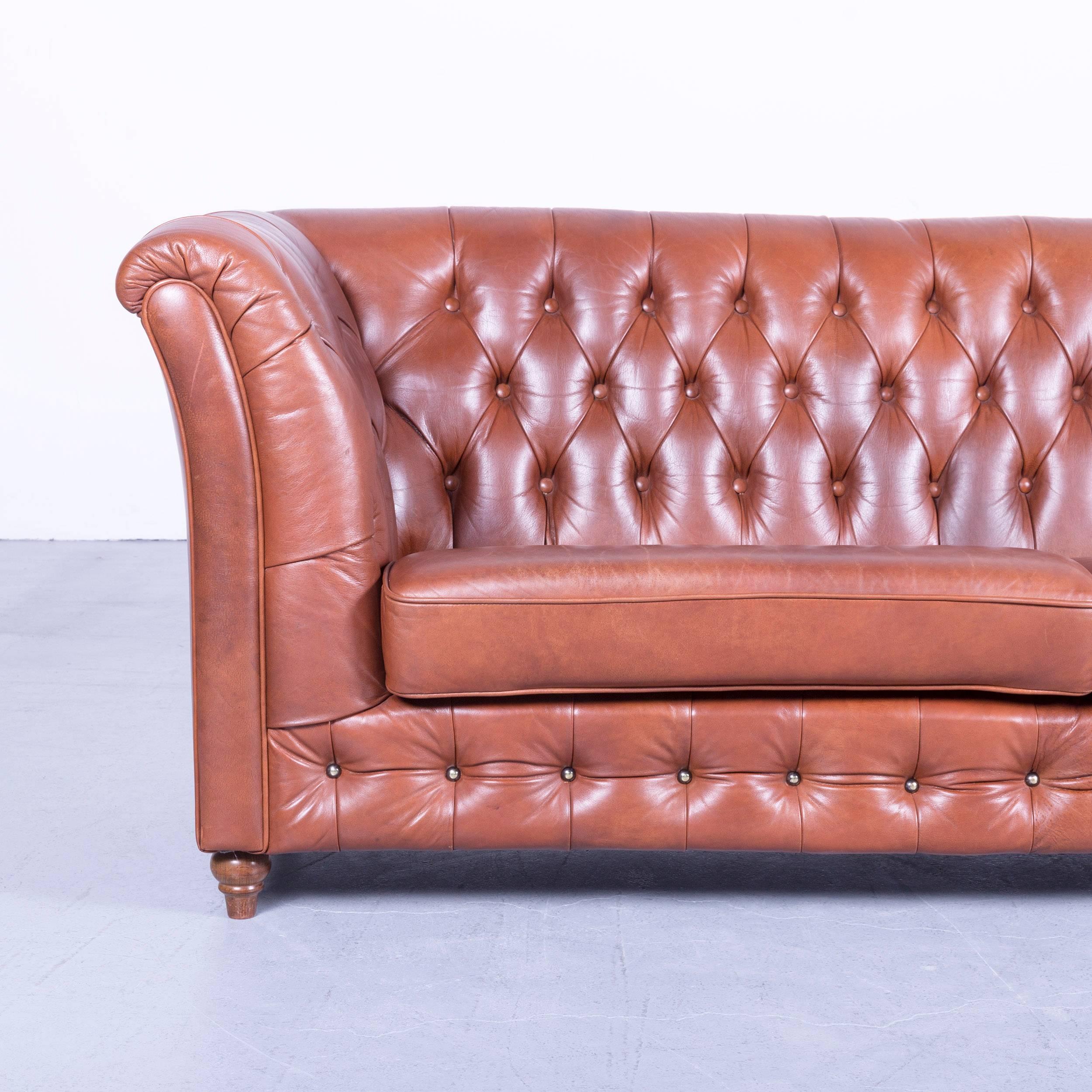 Chesterfield three-seat sofa in brown colour leather couch vintage retro rivets, made for pure comfort and elegance.