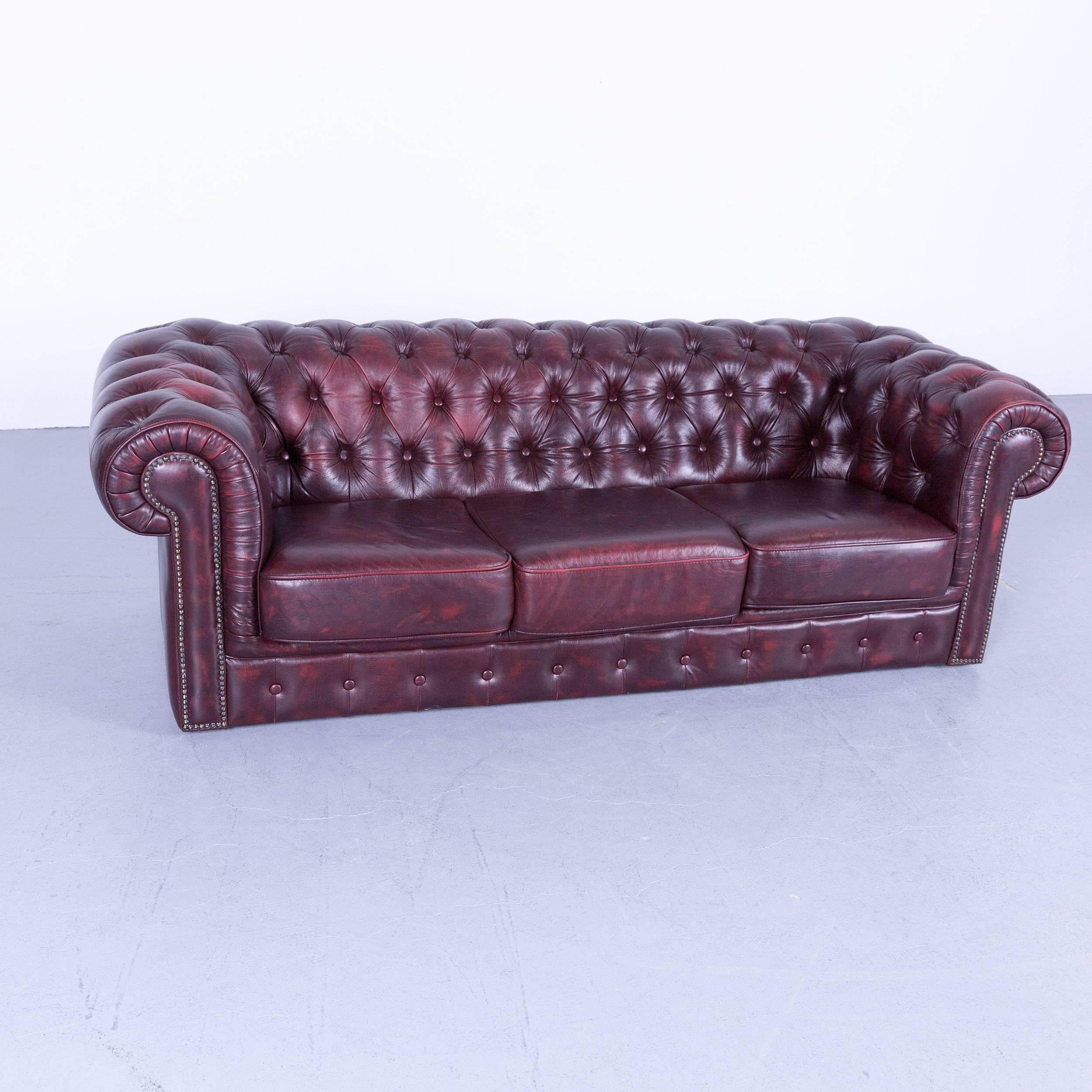 Chesterfield three-seat sofa red leather couch vintage retro rivets, made for pure comfort and elegance.