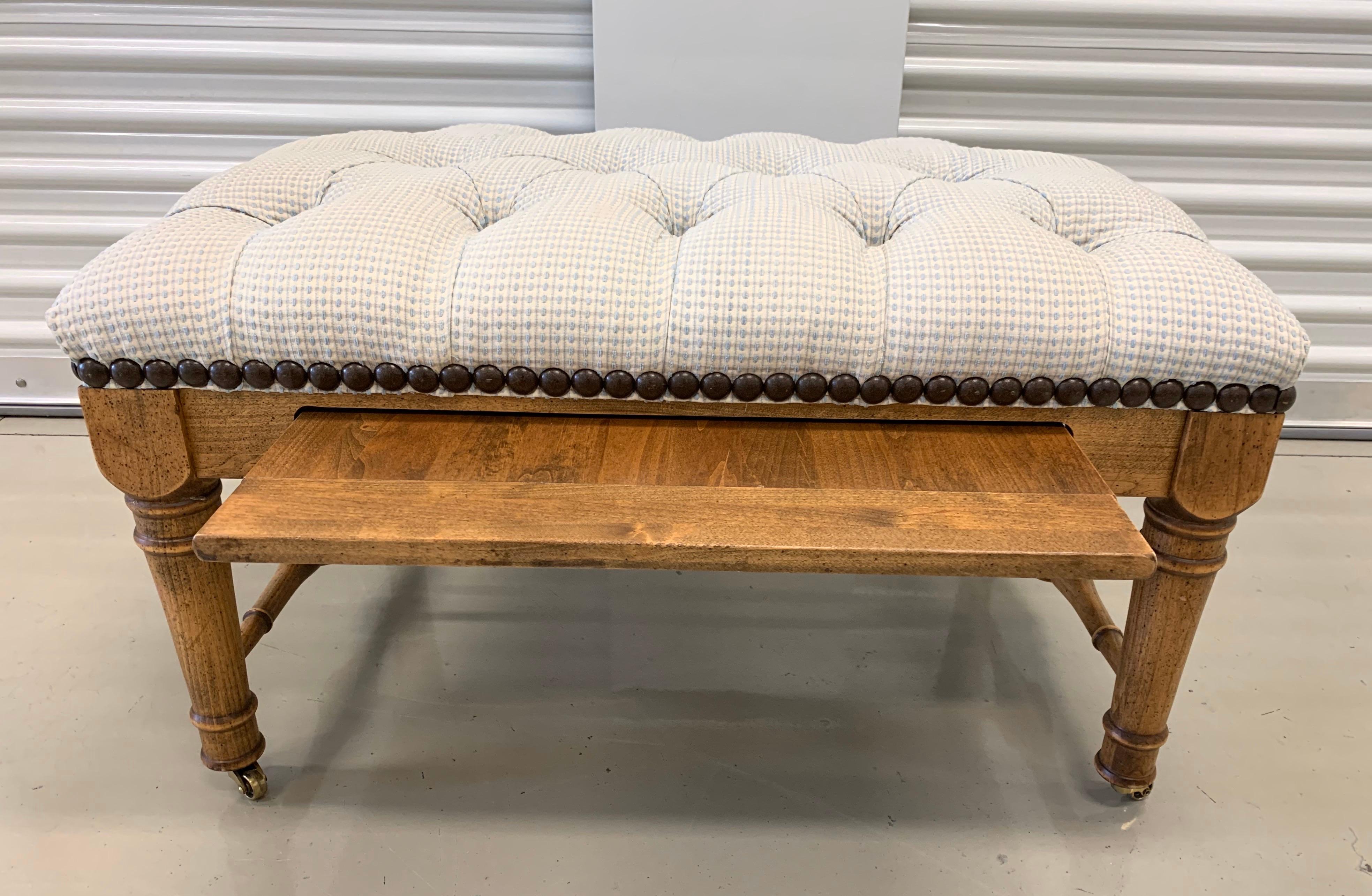 Unusual dual purpose cocktail table with sliding pull out shelf or use is as a bench.
Elegant tufted upholstered top and adorned with nailheads at perimeter.