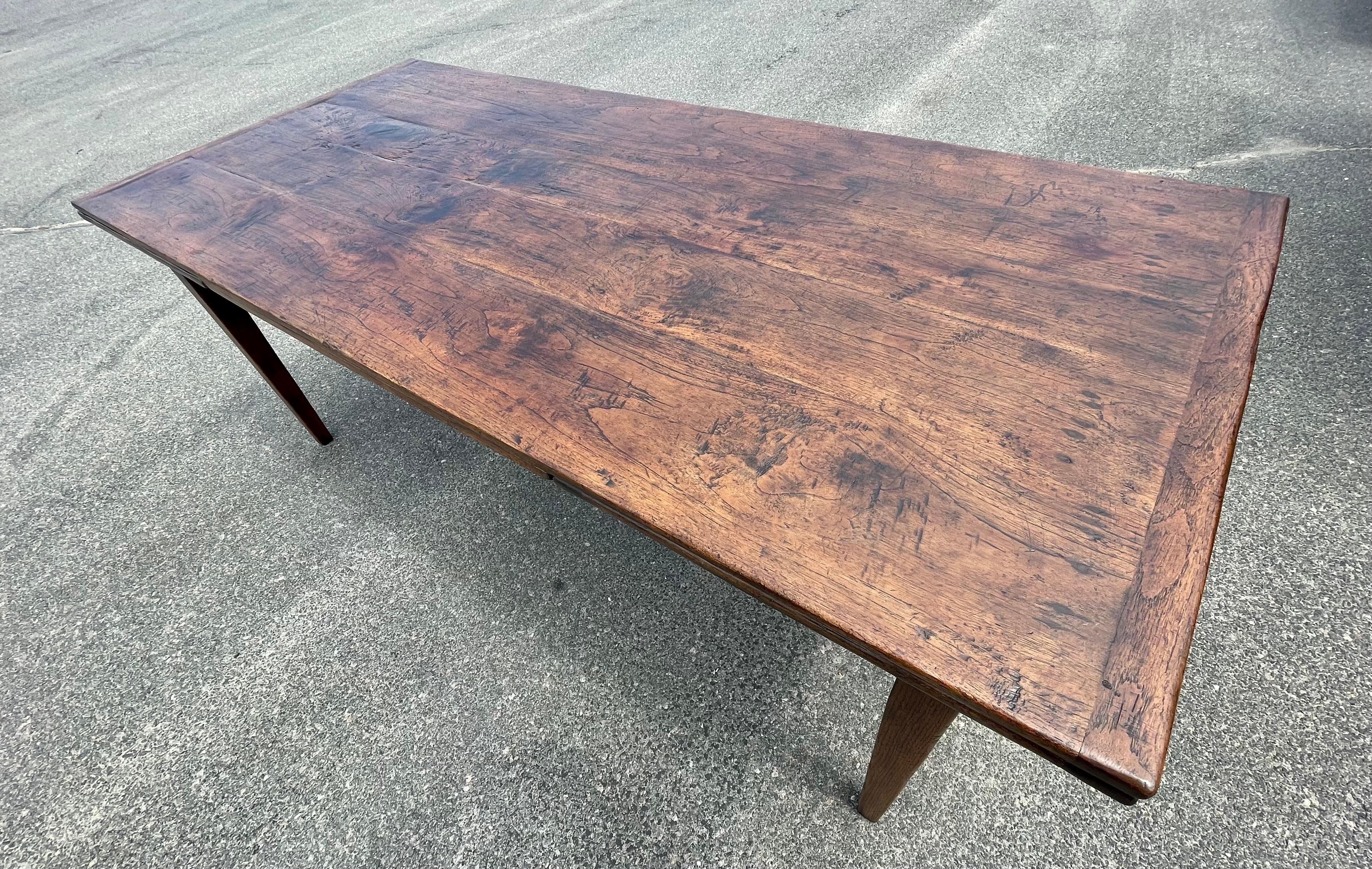 Chestnut draw leaf table with rich oaky colored top and nice figuring, on taper legs.  Extends to 131 inches when open.