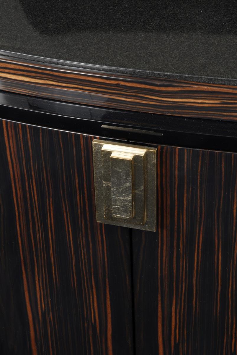 The Argentine buffet is a sleek and compact buffet. Made out of chestnut pommele, it has black and silver detailing which are contrasted by its black granite top. A metal handle acts as an accent to the piece. 

All our work is made to order on a