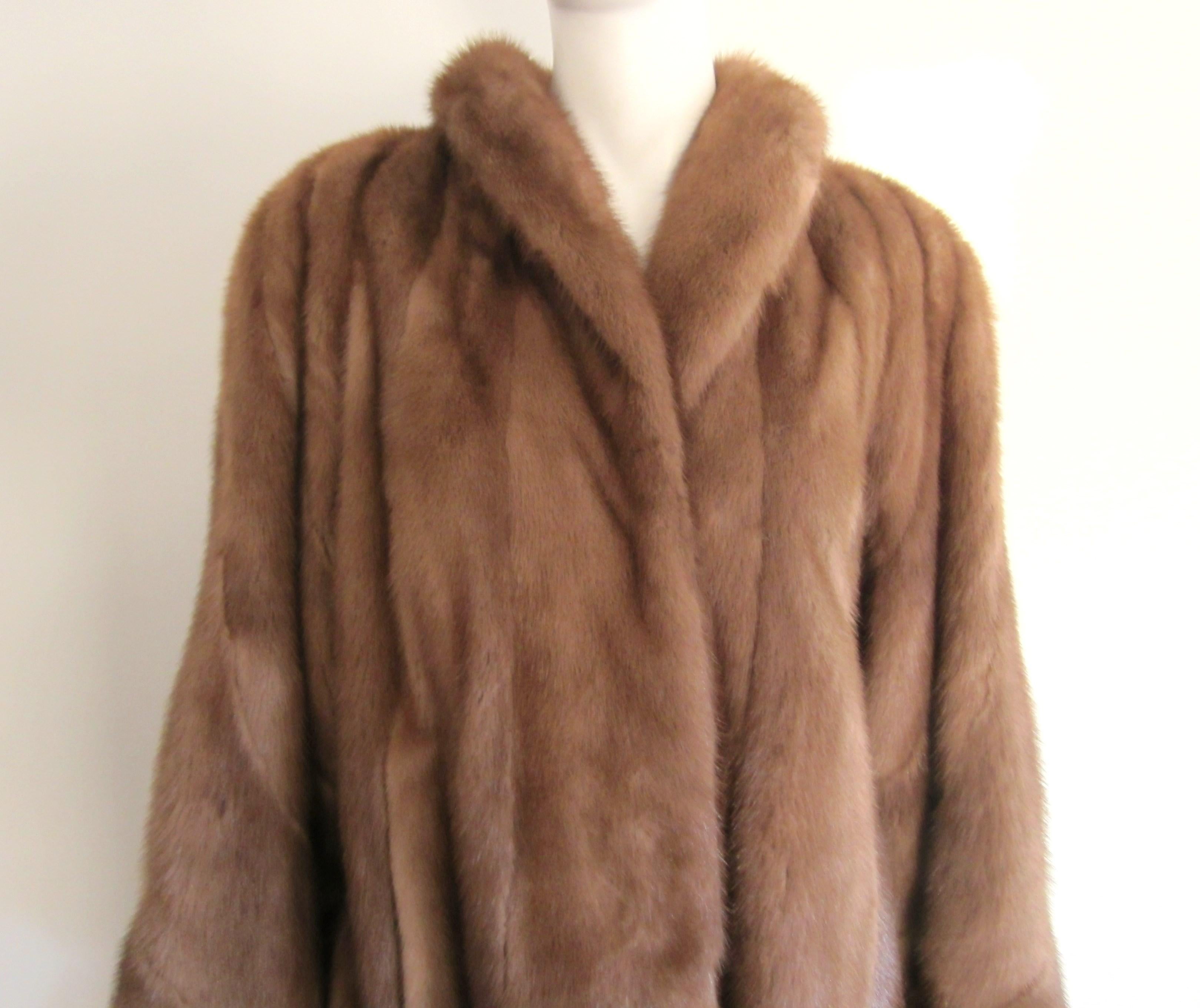  MINK 3/4 LENGTH SWING COAT.  Multi-directional panels on sleeves and the bottom of the coat. Soft and supple mink, no issues. Large swing on this one! 3 hook and eye closures. Slit pockets. Wide sleeves. Measuring Up to 46 in. chest, Up to 48 in.