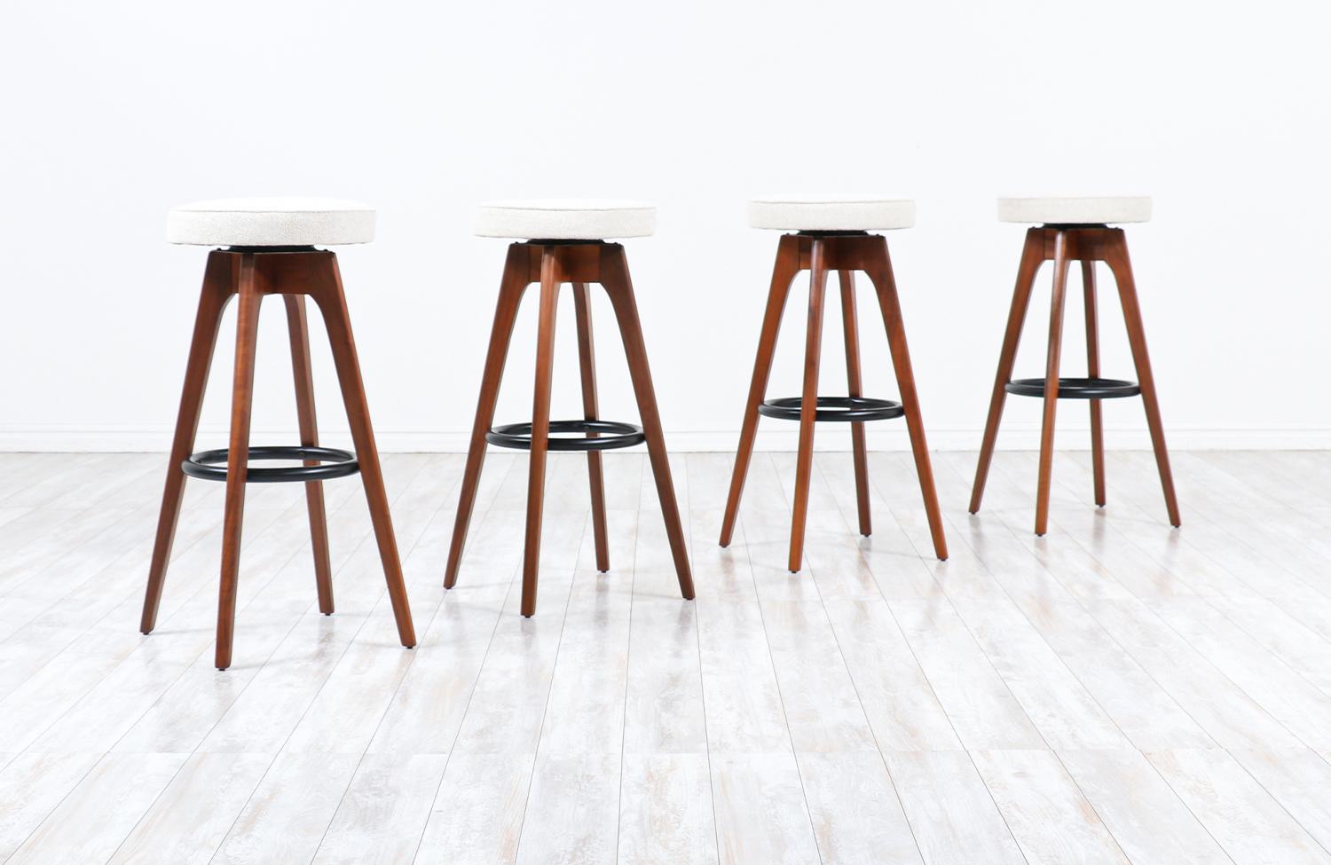 Chet Beardsley sculpted walnut swiveling stools for living design.