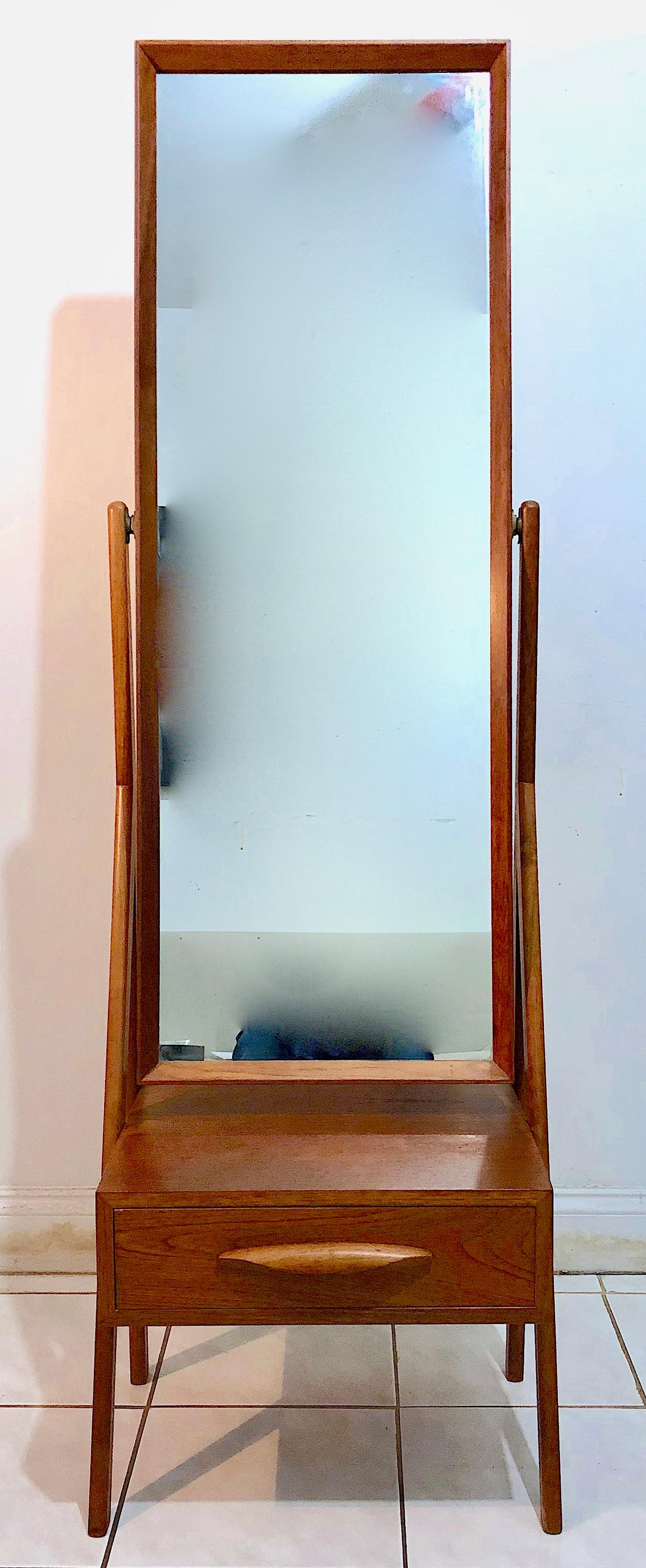 Handsome cheval teak full length dressing mirror with small table and drawer. The mirror swivels. Very nicely designed and detailed.