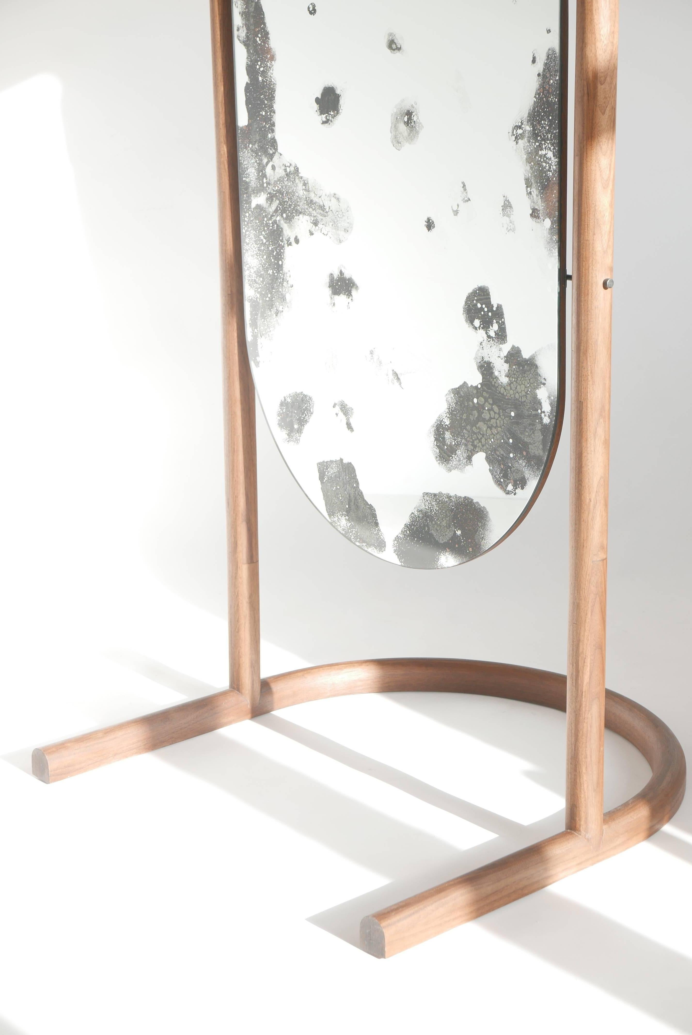 This custom Cheval style pivoting floor mirror is a freestanding version of our wall-hanging Oxbow mirror.  

Our Oxbow mirror combines a perfect arc, mystic mirror effects, and a simple platform for display or function. The oxbow form is derived