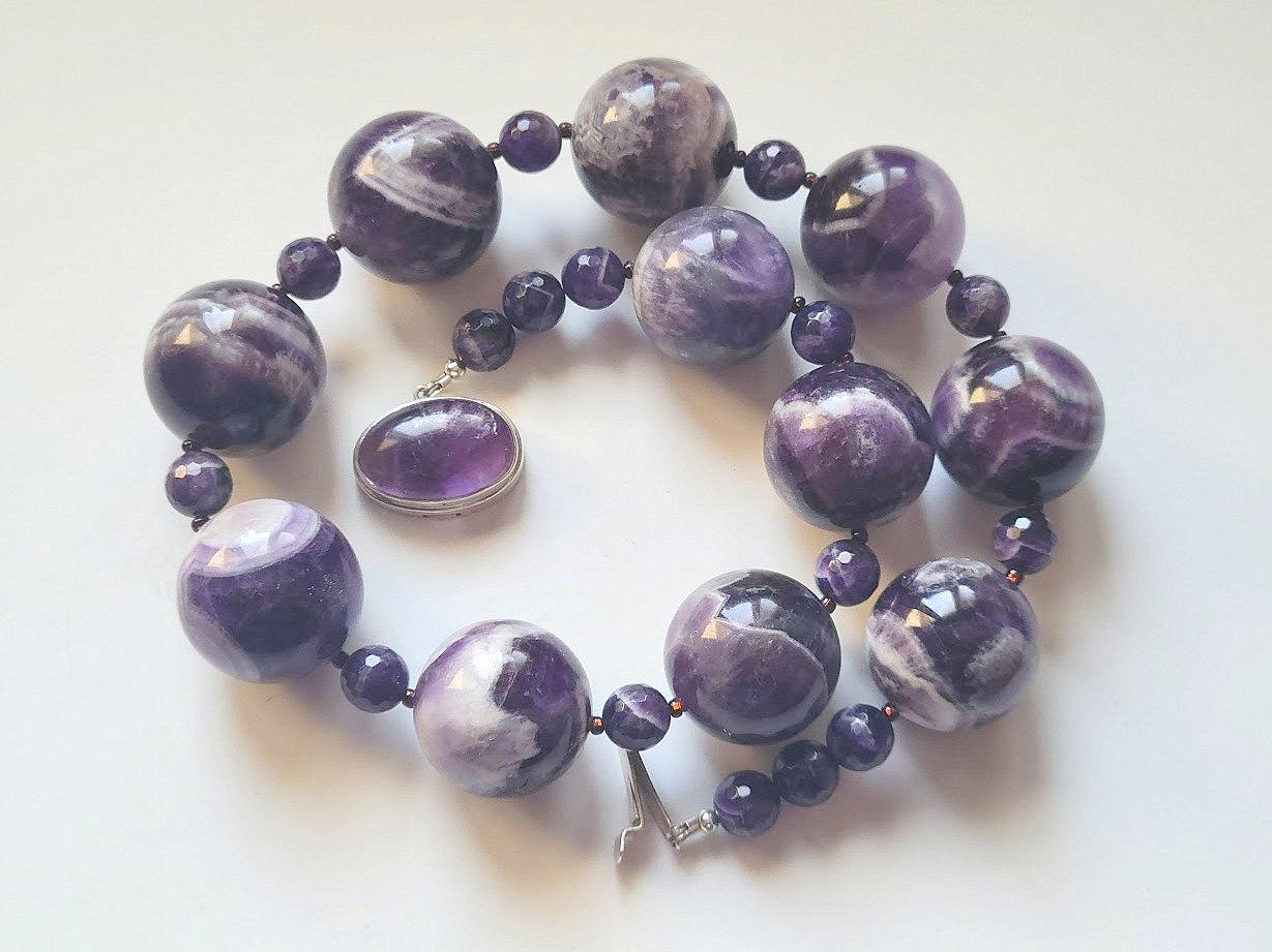 Exceptional necklace of natural chevron amethyst beads of very rare large size.
The length of the necklace is 21 inches (53 cm). The rare size of the huge smooth round beads is 27.5 mm. The size of the faceted round beads is 10 mm.
Chevron Amethyst