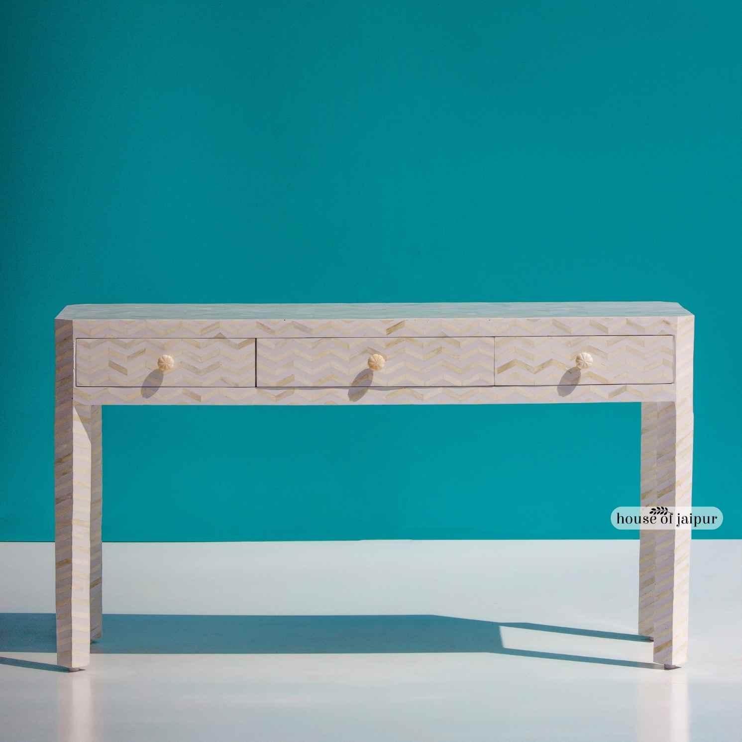 A modern take on traditional craftsmanship, this Bone Inlay Console Table features a refined chevron zig-zag pattern meticulously hand-laid across the entire surface. Each bone piece is individually cut, shaped and placed by skilled artisans,