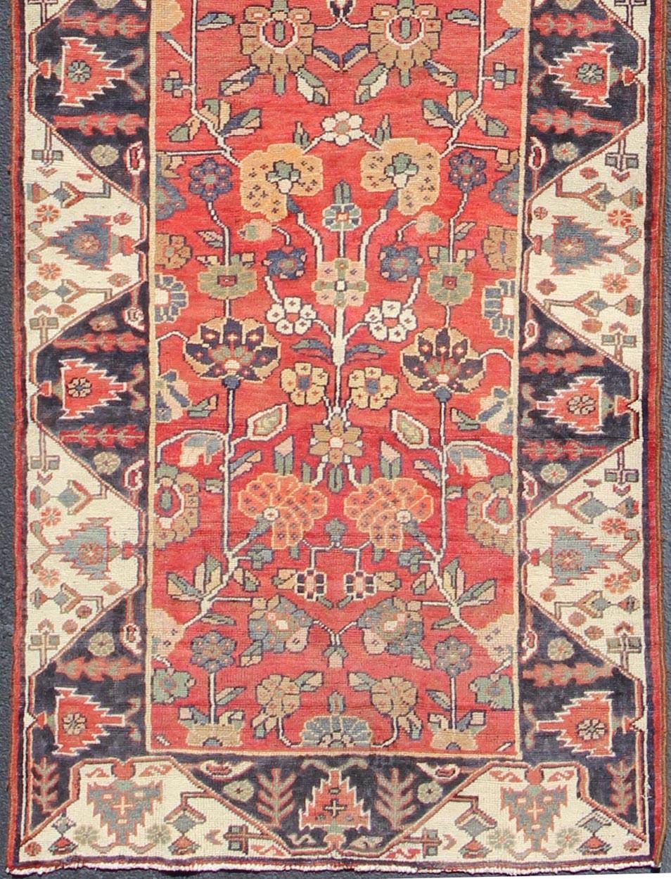 Red, black, and ivory vintage Persian Karadjeh runner with chevron border vining geometric floral designs, rug h-407-3, country of origin / type: Iran / Karadjeh, circa 1950.

This mid-20th century, handwoven vintage Persian Karadjeh runner