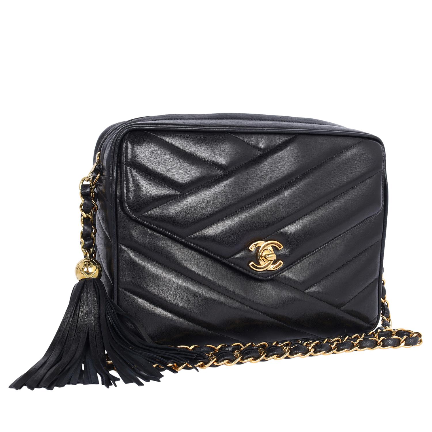 Authentic, pre-owned classic vintage Chanel black quilted leather camera shoulder cross body bag. This bag is in amazing condition! Features black quilted lambskin leather with 24kt gold plated hardware, a long woven chain strap, and a zipper top