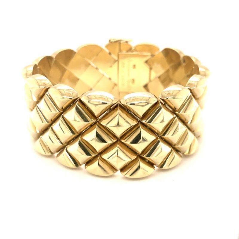 Wide-strap bracelet in 14K yellow gold with raised chevron and diamond-shaped links featuring a high polish finish and displays wonderful dimension when worn.

Striking, dramatic, substantial.

Additional information:
Metal: 14K Yellow Gold
Circa: