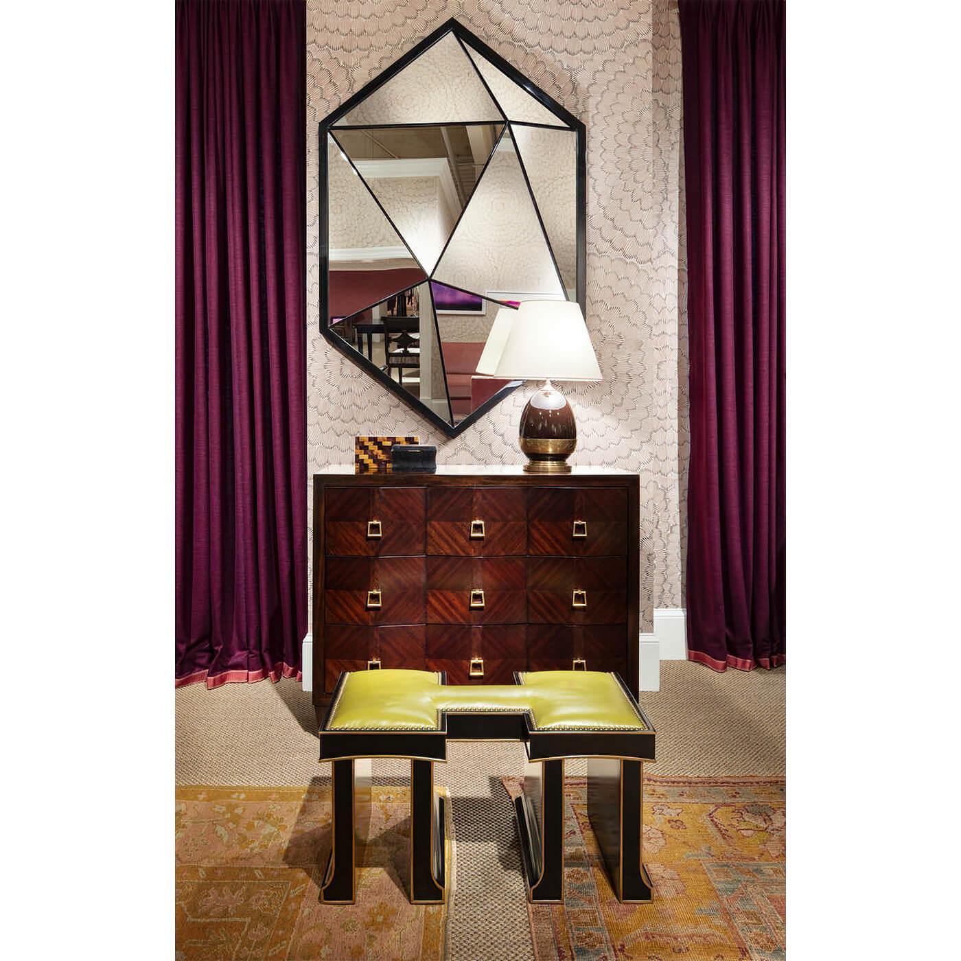 A Mid-Century modern inspired three drawers dresser. Each long drawer with a trio of brass drop handles distinguishes this chest of drawers. Modern, geometric, and sculptural, this works in any floor plan. Square tapered legs capped in brass.