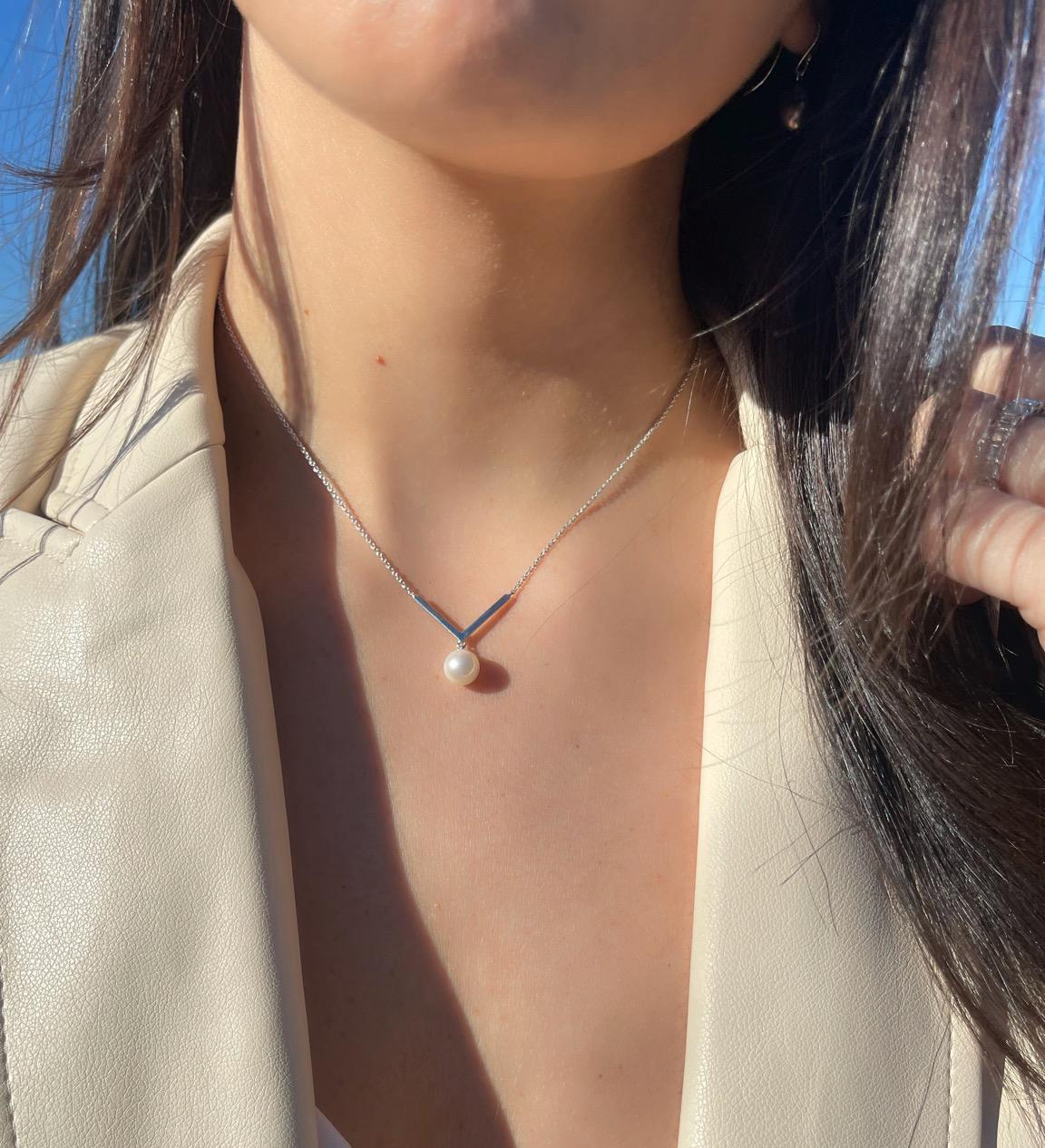 This popular style features a round Freshwater white pearl measuring 7.5-8mm dangling from a chevron style detail on a .925 Sterling Silver chain. This is a perfect necklace to layer or wear or its own. Enjoy this necklace as an everyday piece!