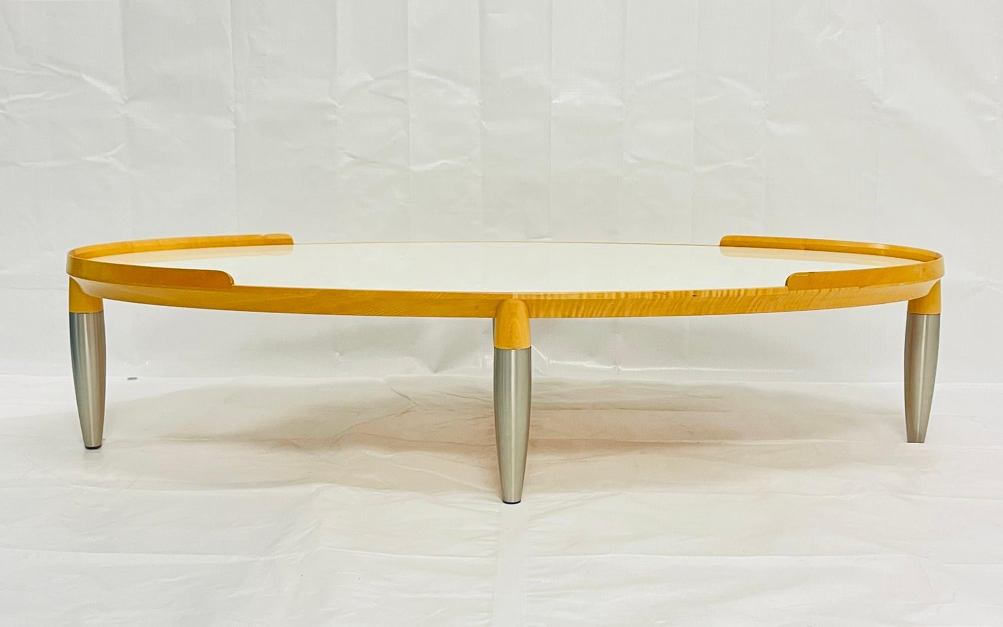 Elegant and sculptural “Tiche” coffee table designed by Chi Wing Lo for Giorgetti, Italy, circa 1990s. This sophisticated piece exemplifies Giorgetti’s masterful blend of craftsmanship and innovation, combining solid maple wood, reverse-painted