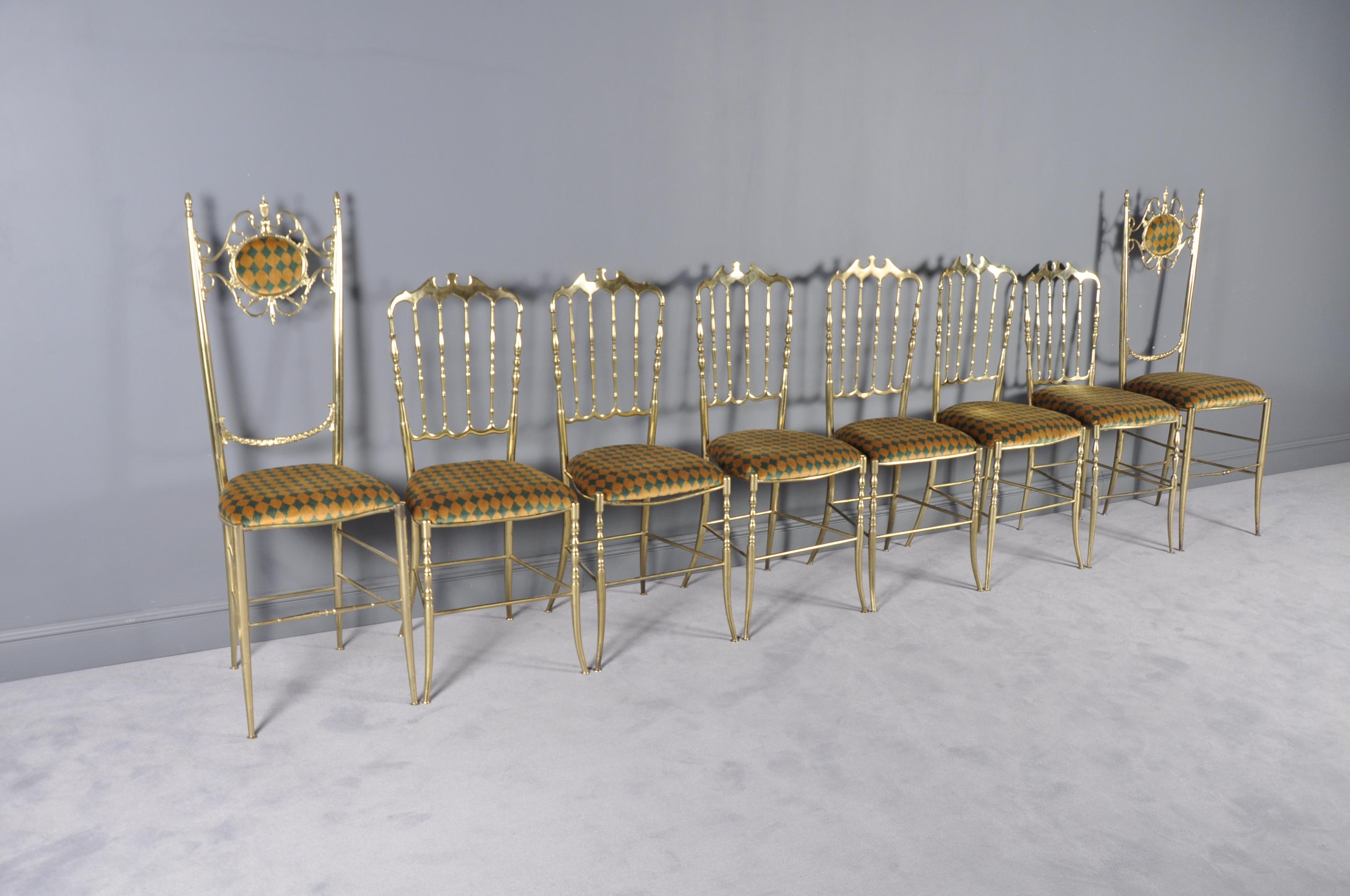 This set of eight lightweight Chiavari chairs in the Hollywood Regency style is made of solid brass. The pieces feature crest rails, spindled backs, and new multicolored velvet upholstery.
The Chiavari chairs are named after the Italian city where