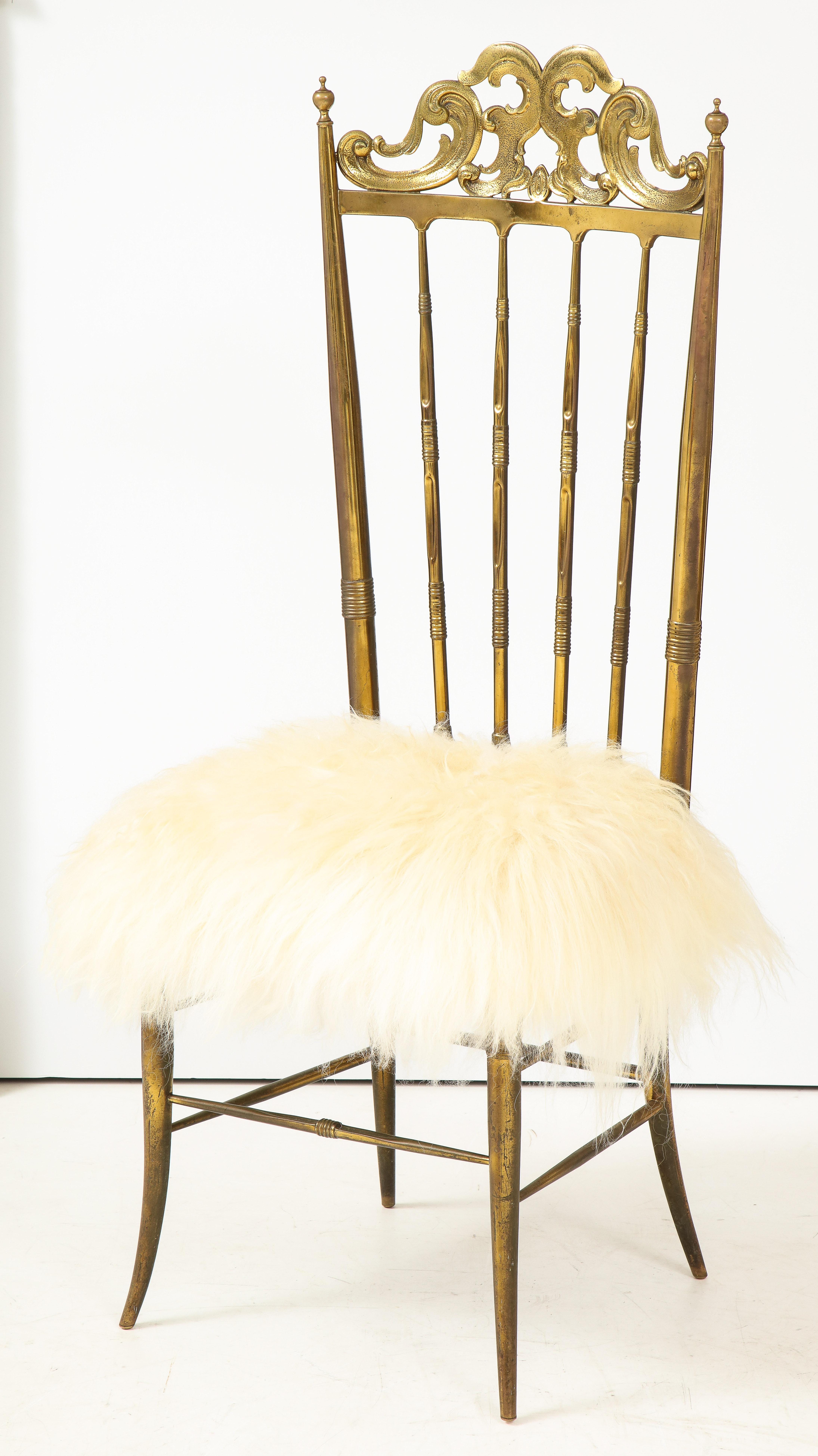 Italian midcentury Classic chair by Chiavari with great aged brass frame and new long haired sheepskin seat.