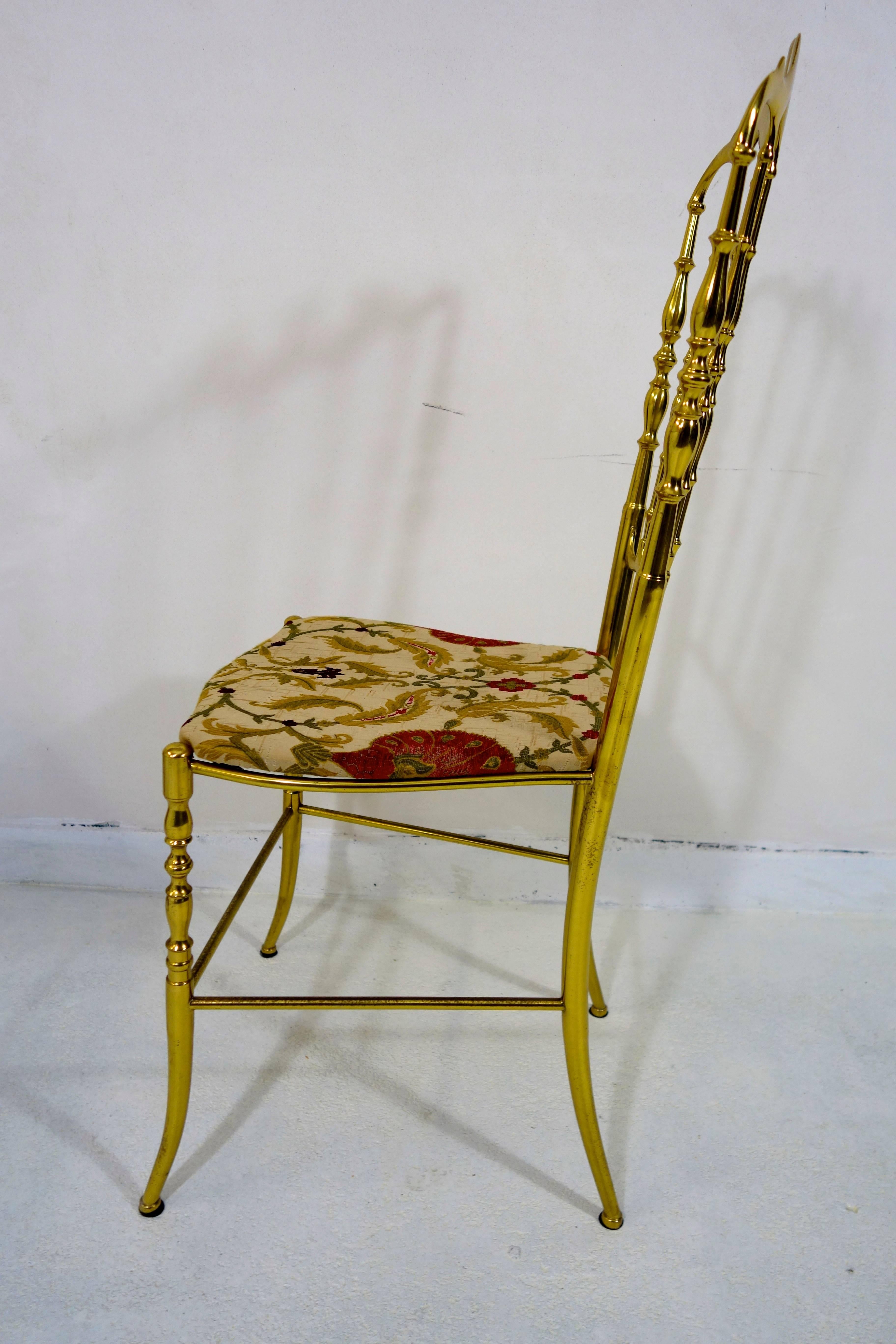 Pair of two Shiny Brass Chairs in Hollywood Regency style made by Chiavari.

They have been newly reupholstered in an Indian style eclectic fabric.