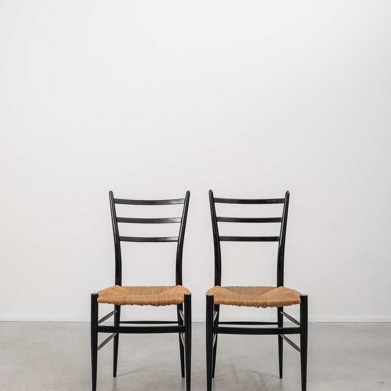 This set of 2 elegant Spinetto chairs have a very thin profile with black ebonized frames and wicker seats, manufactured in the 1950s by Chiavari, Italy. These chairs were the inspiration for Gio Ponti’s famous Superleggera chair.

 