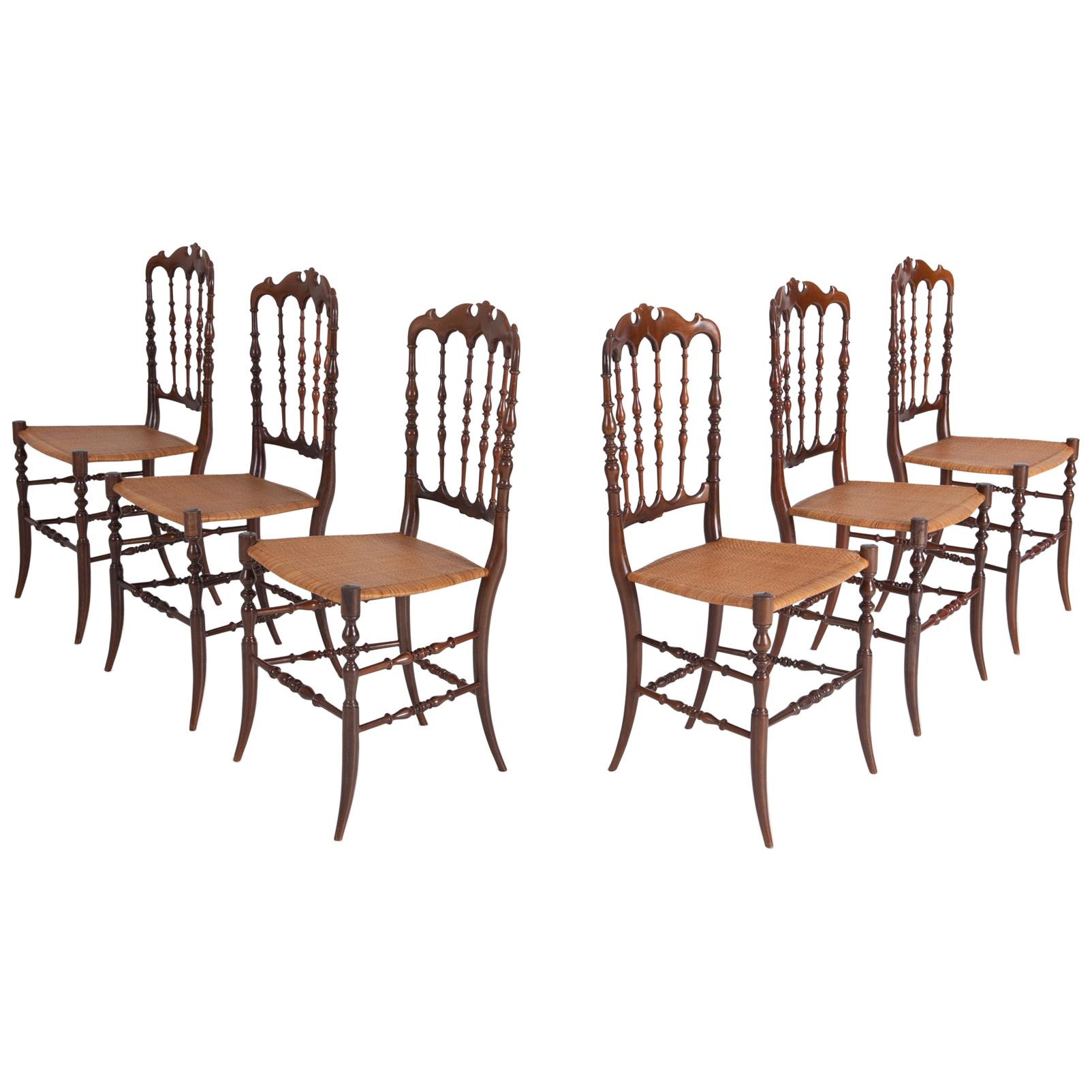 Postmodern dining chairs, set of six, Chiavari, Italy, the 1970s

Reminding of Ponti's ultra leggera, these lightweight dining chairs incorporate both a classical look with a modern design.
Provided with a beautiful crest rail, spindled back, and