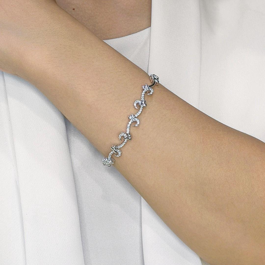 Elevate your style with this very chic 18K white gold bracelet, a masterpiece of subtle sparkle and sophisticated design. Sixty meticulously set natural round brilliant diamonds, boasting an impressive total carat weight of 0.60ct, create a