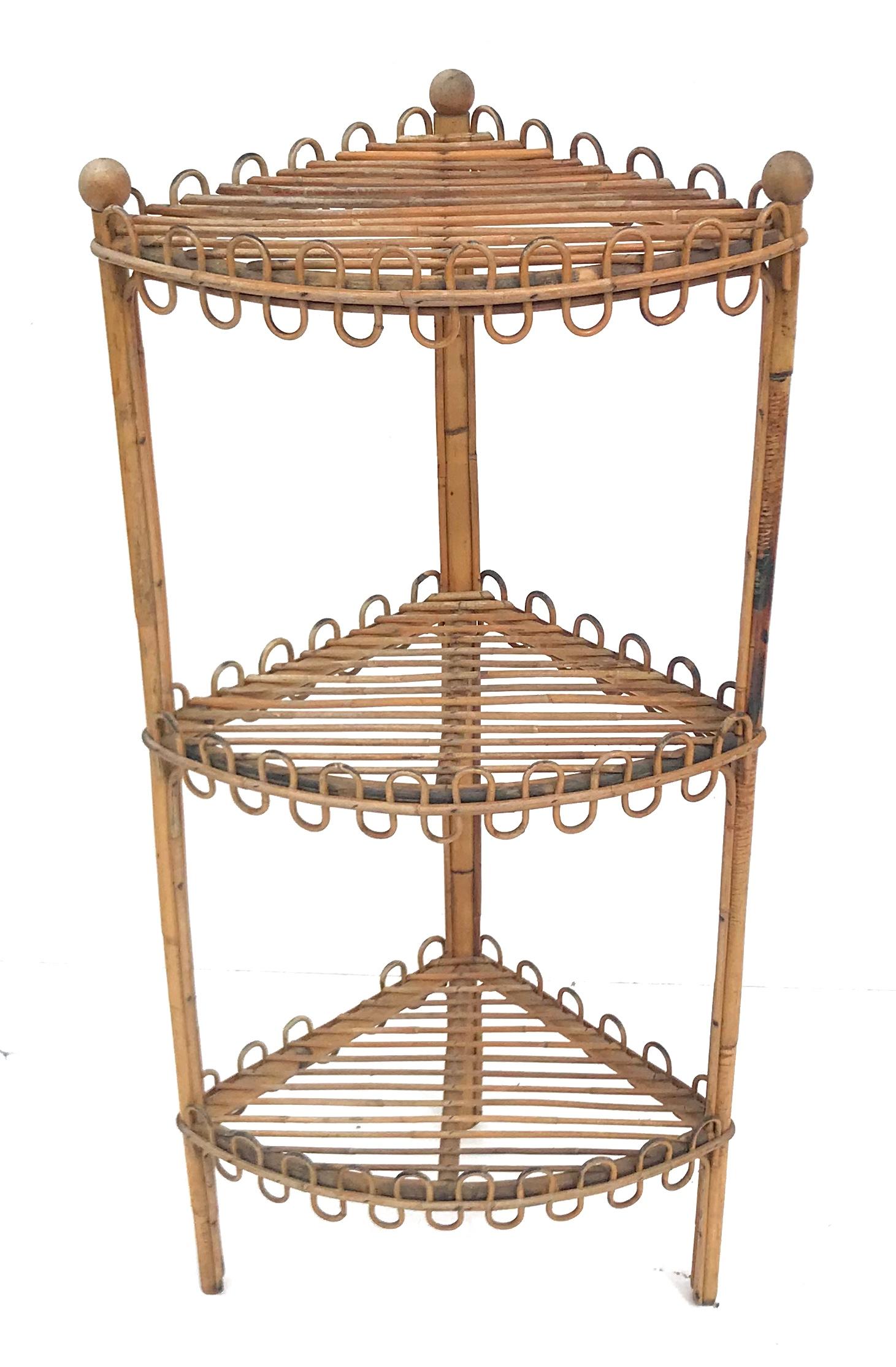 Wonderful sculpted French rattan corner shelf from the 1950s in the style of Jean Royere. We’ve never seen this form before!