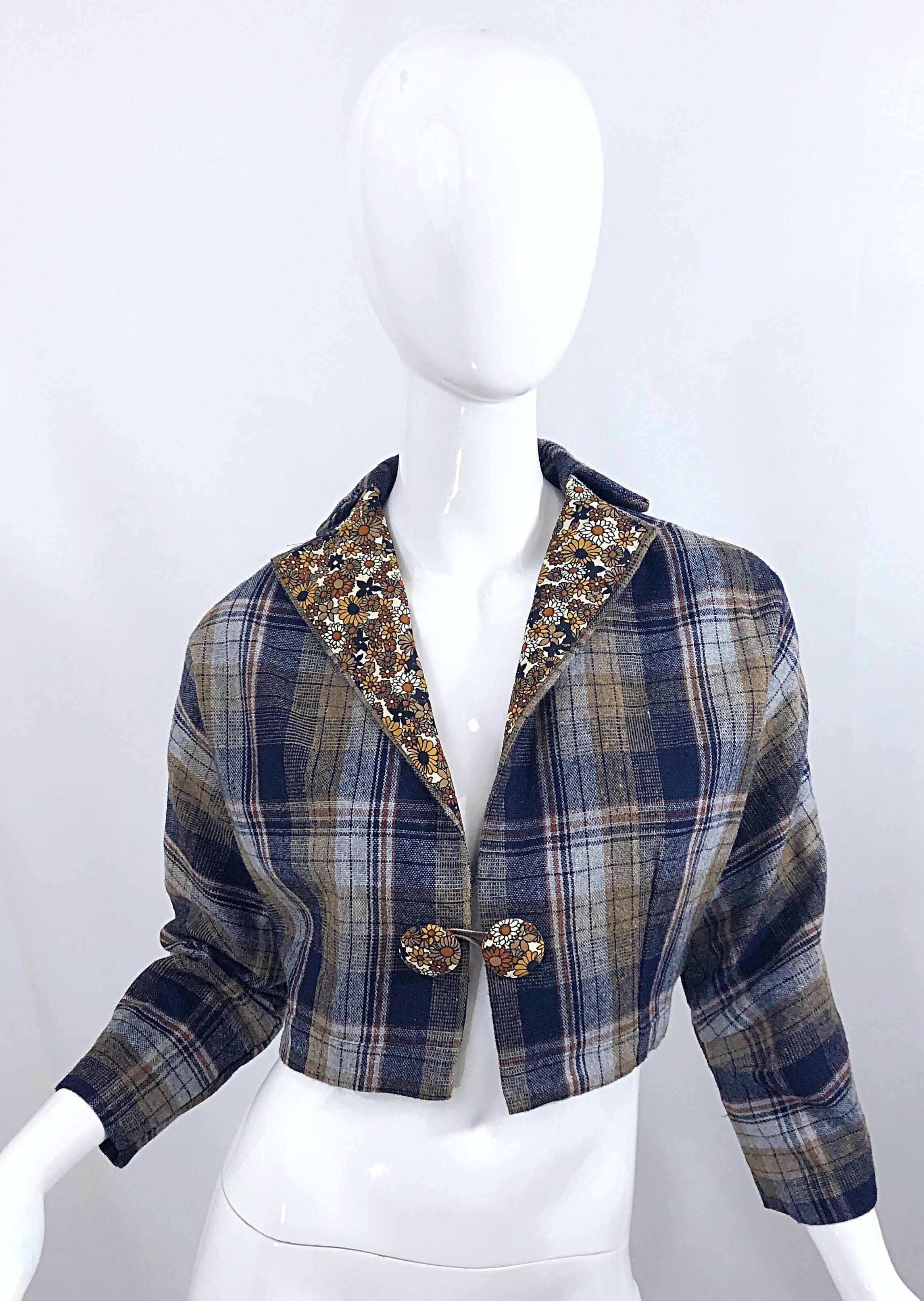 Chic vintage 60s plaid and flowers printed wool / silk cropped bolero jacket! Features allover plaid, with a small floral silk lining that peaks onto the collar and oversized buttons. Dolman sleeves allow this beauty to be worn by an array of sizes.