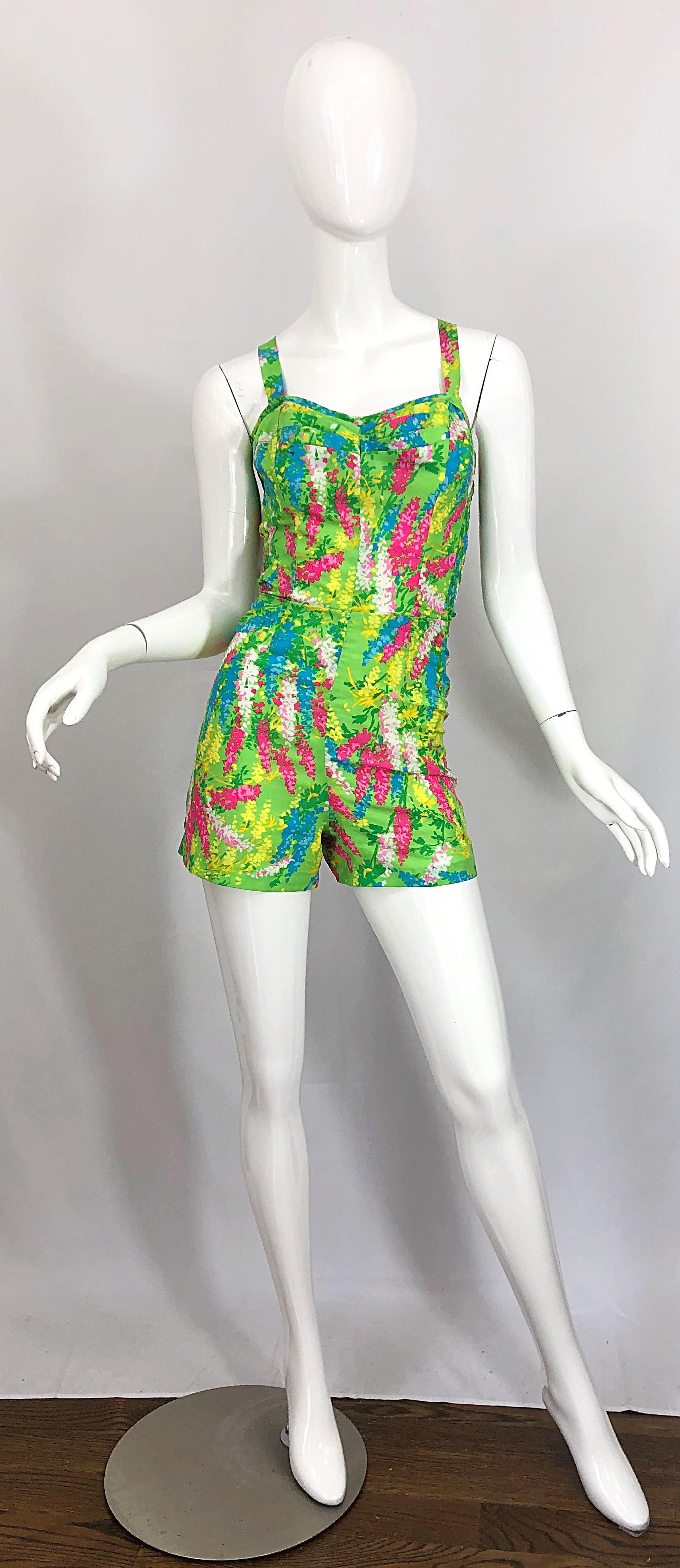 Chic 60s GABAR silk flower print one piece romper jumpsuit! Features a vibrant lime green background with flowers in pink, blue, yellow and white throughout. Adjustable straps can be worn racerback or normal, and features three different button hole