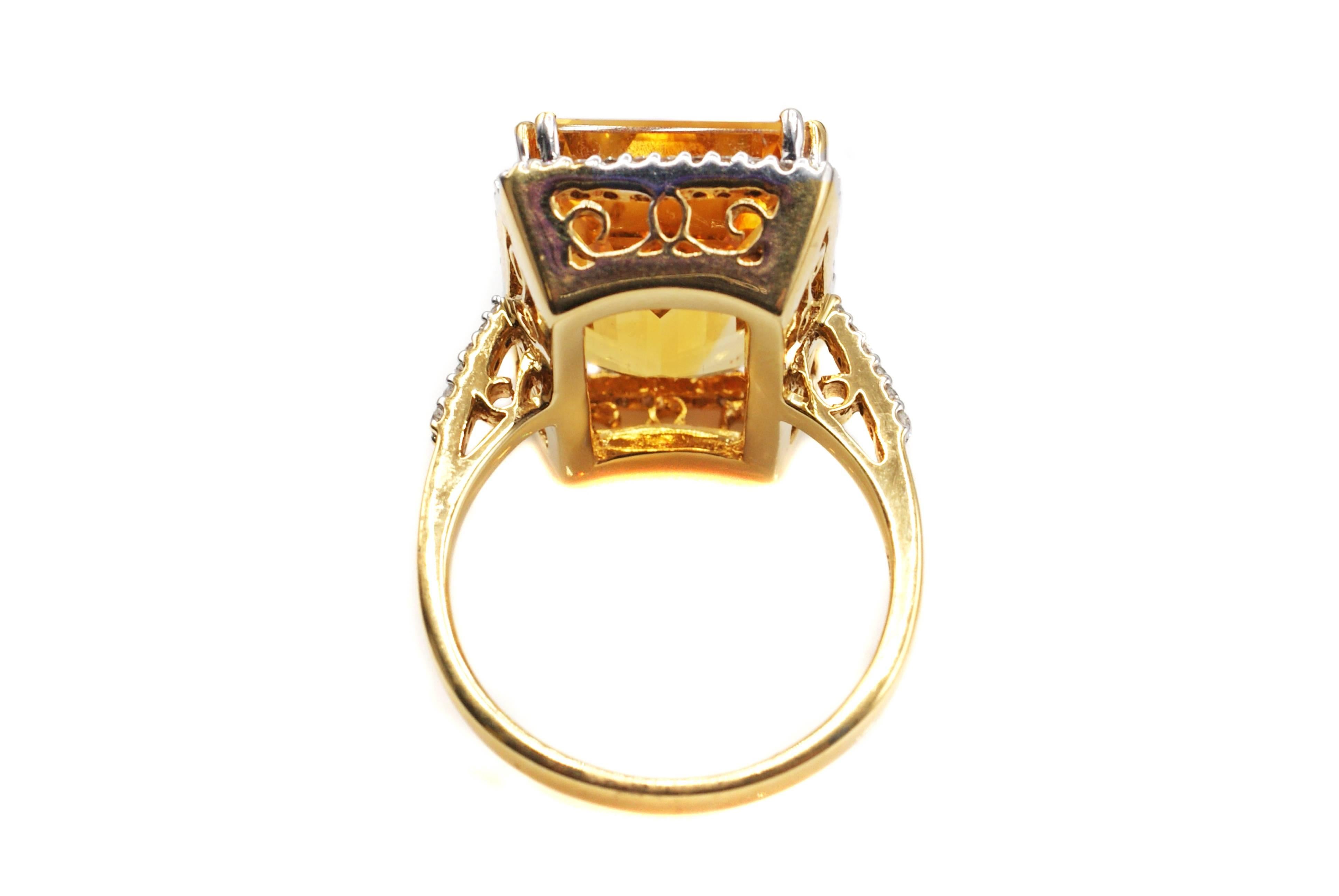 This chic 1960s handcrafted 18 karat yellow gold ring is centrally set with an extremely vibrant lively emerald cut golden citrine. This well cut gemstone displays an amazing amount of color and sparkle and is embellished by a fine halo of tiny