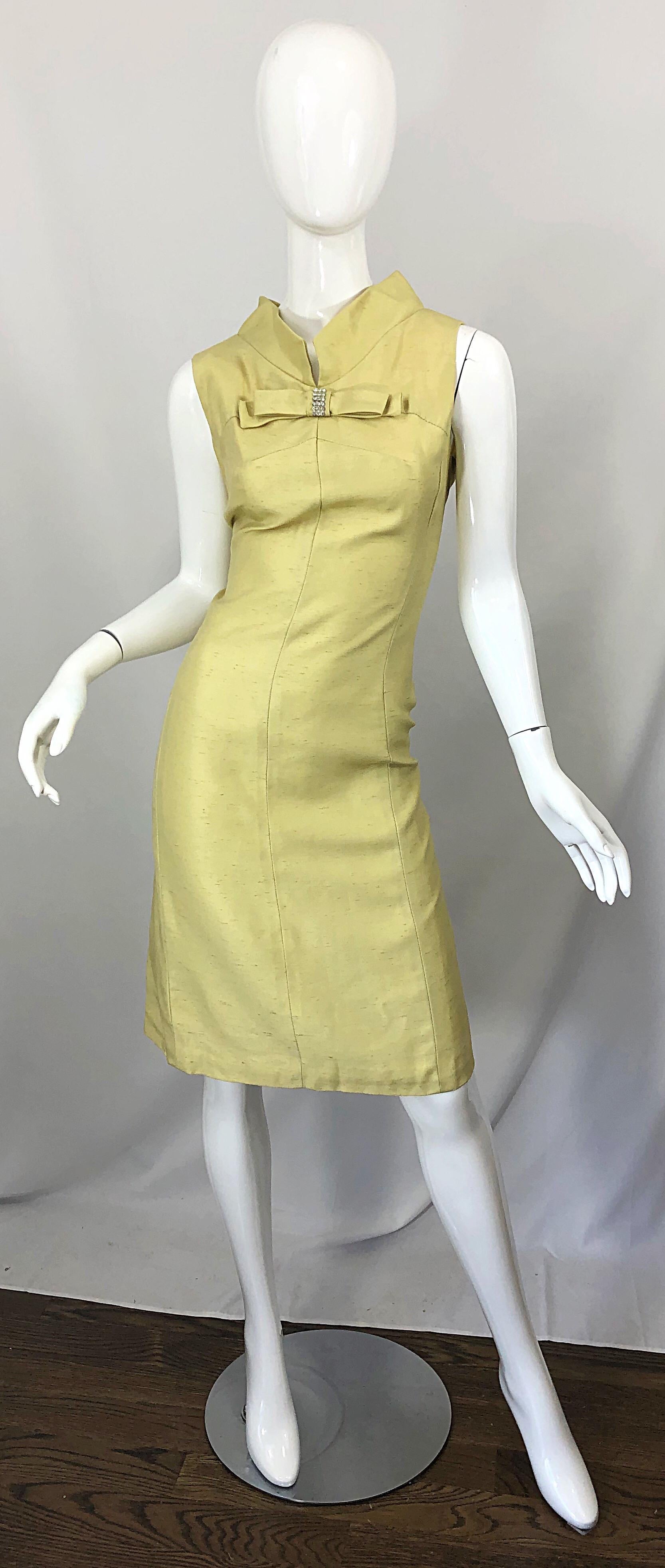 Chic 1960s I MAGNIN pale yellow silk shantung 60s shift dress! Features a bow at center collar encrusted with rhinestones. Tailored bodice with a forgiving shift skirt. Full metal zipper up the back with hook-and-eye closures. Very well made with