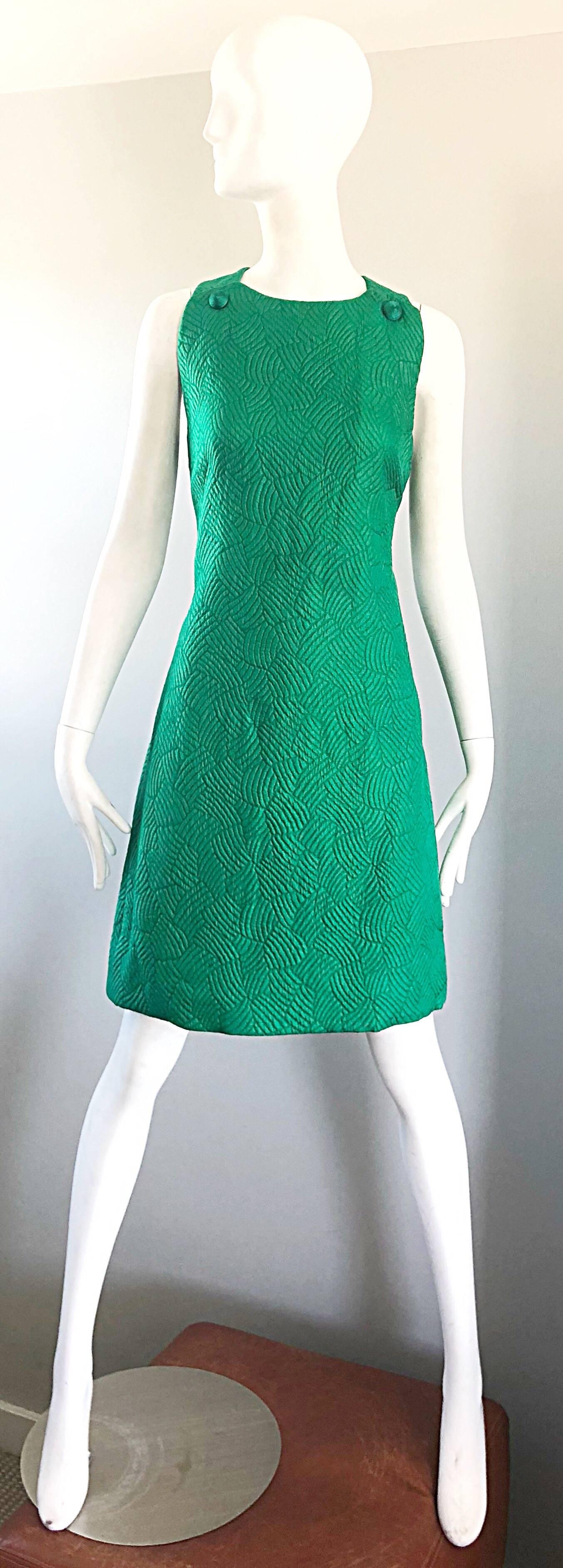 Beyond chic 1960s Kelly green quilted silk shift dress and matching cropped pillbox jacket ensemble! The perfect Kelly green color really set this rare set apart from others. The shift dress features a racerback that has hidden hook-and-eye closures
