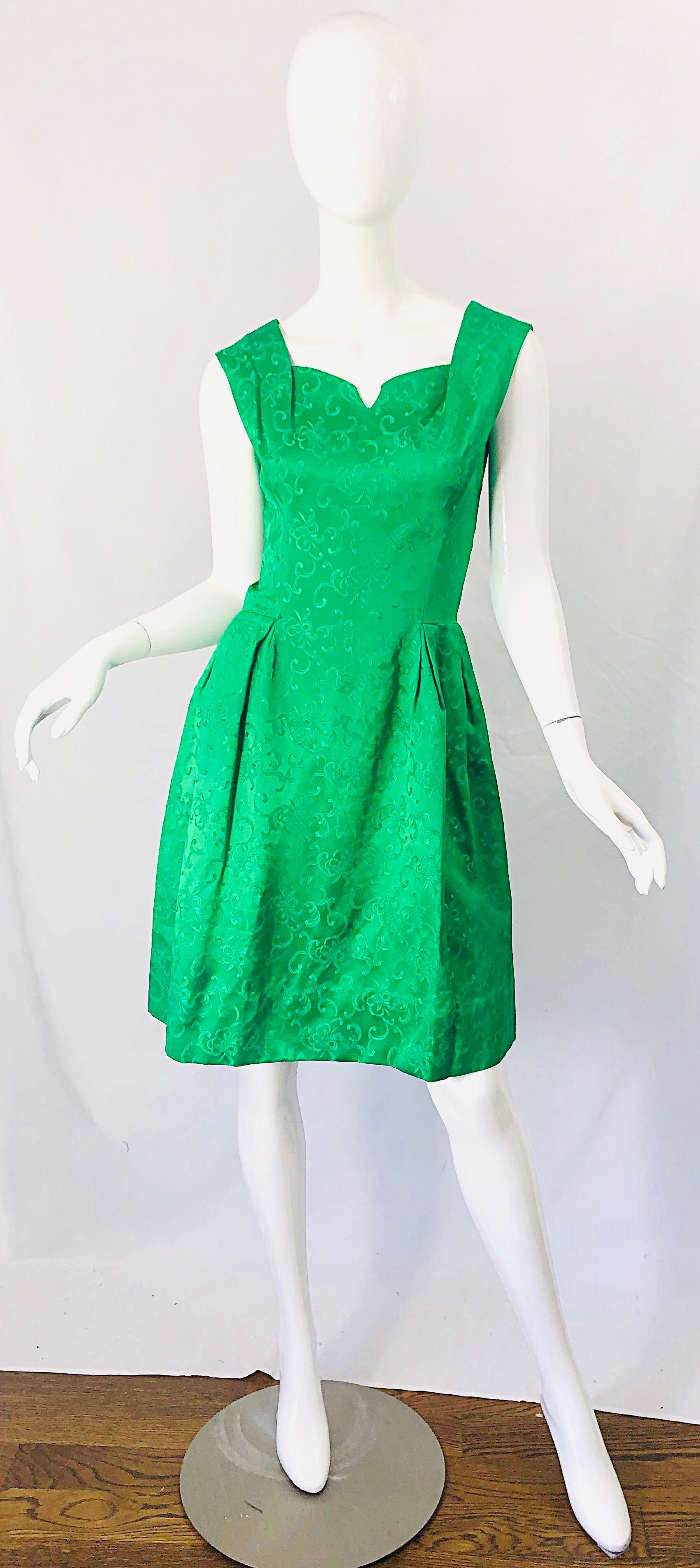 Chic early 60s kelly green silk damask A-Line dress ! Features the perfect rich hue of green. Tailored bodice with a forgiving A-Line skirt. Full metal zipper up the back with hook-and-eye closure. Intricate pleats and folds. Very well made with