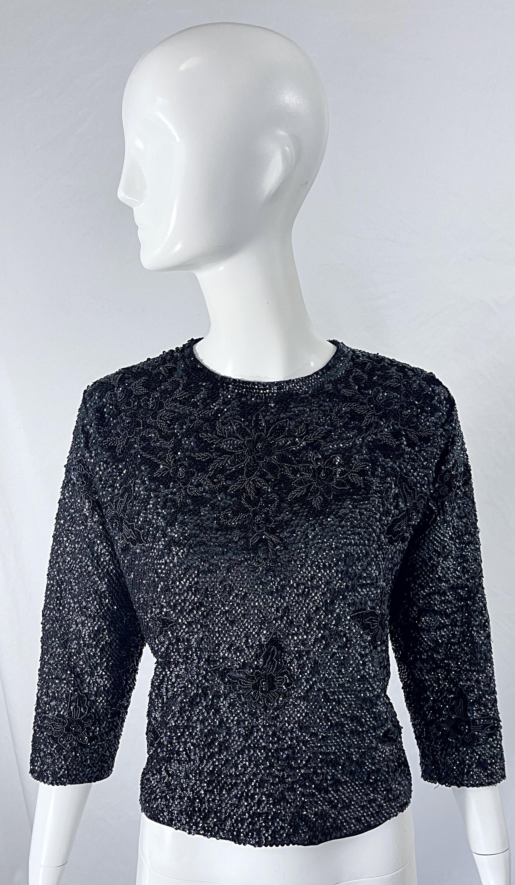 Chic early 1960s black sequin beaded 3/4 sleeves wool sweater top ! Features thousands of hand-sewn sequins and beads throughout the entire sweater. Full metal zipper up the back with hook-and-eye closure. Super soft wool has lots of stretch to it.