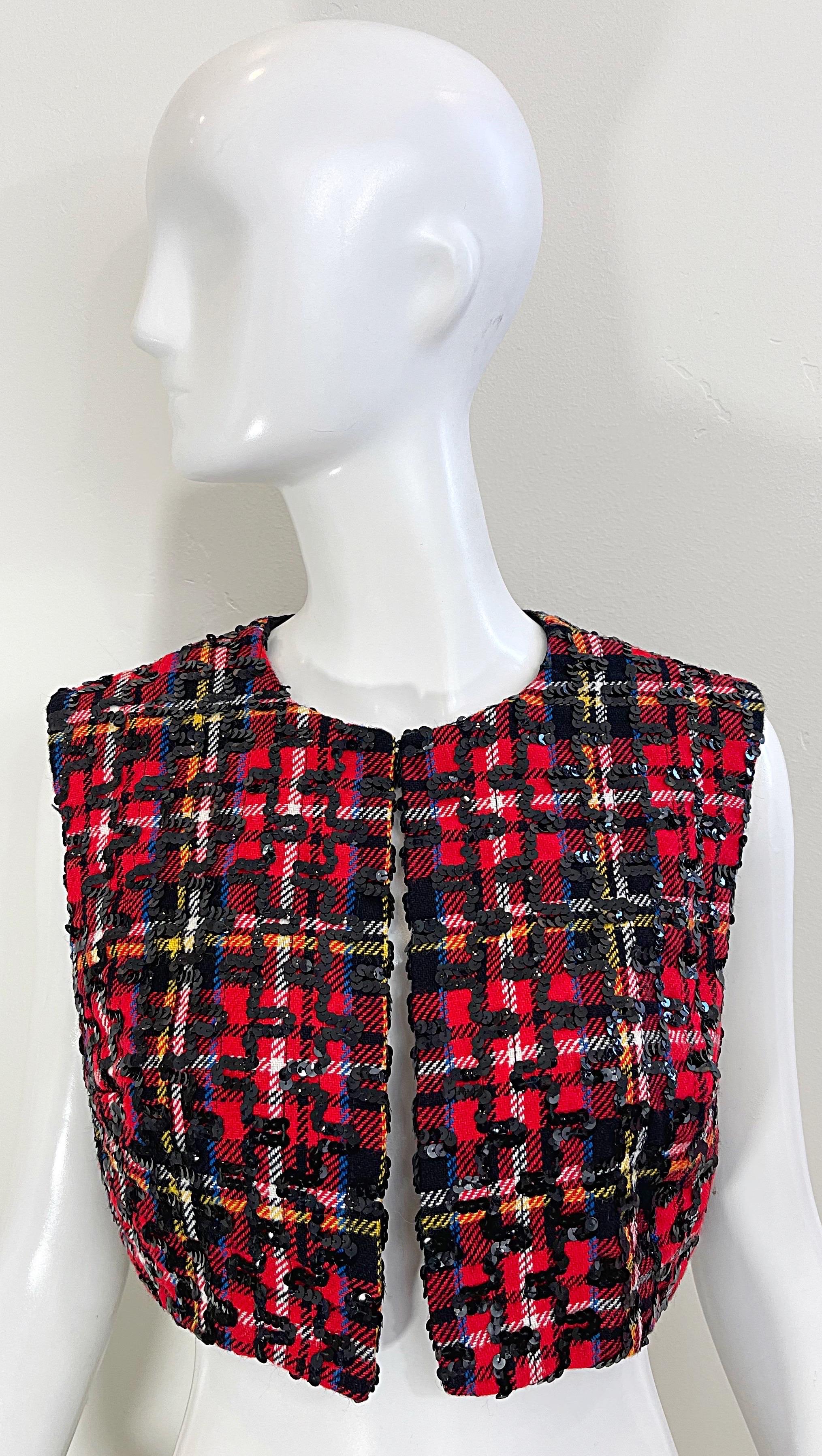 Chic 1960s LEE JORDAN red tartan plaid wool cropped sequin vest ! Features stripes of blue, yellow, black and white. Hundreds of hand-sewn black sequins throughout. 
Single hook-and-eye closure at top center neck. 
In great condition 
Made in