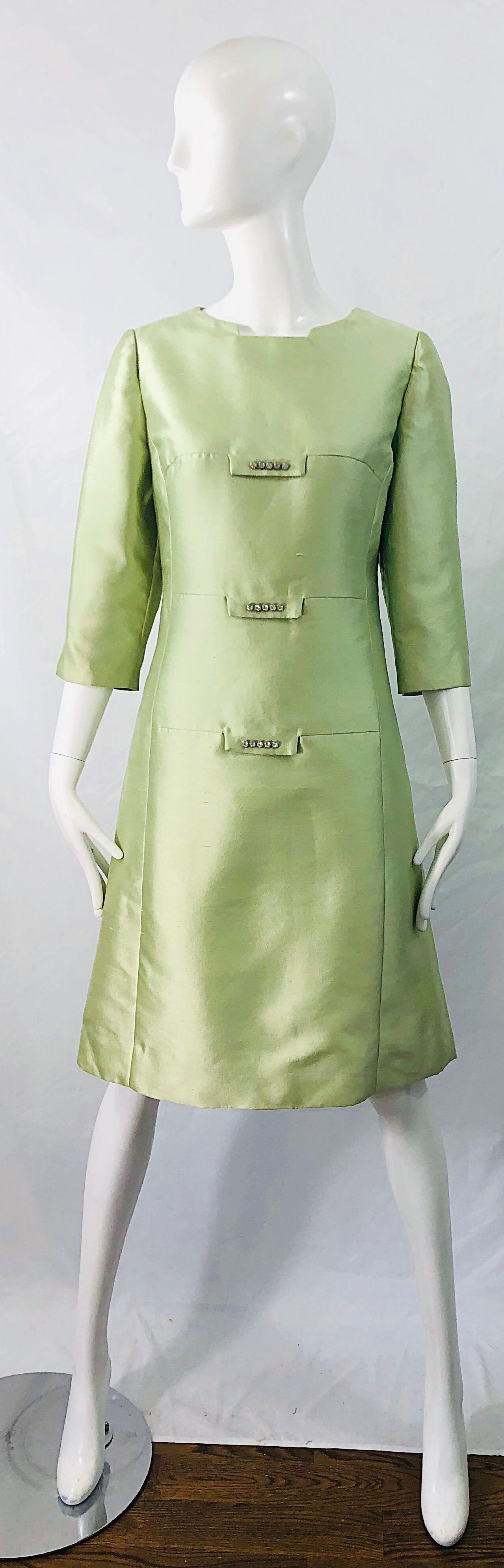 Chic 1960s mint green raw silk shantung rhinestone encrusted A-Line dress ! Features a architectural neckline. Tailored bodice with a forgiving A-Line skirt. Hidden zipper up the back with hook-and-eye closure. Fully lined. Perfect for any day or