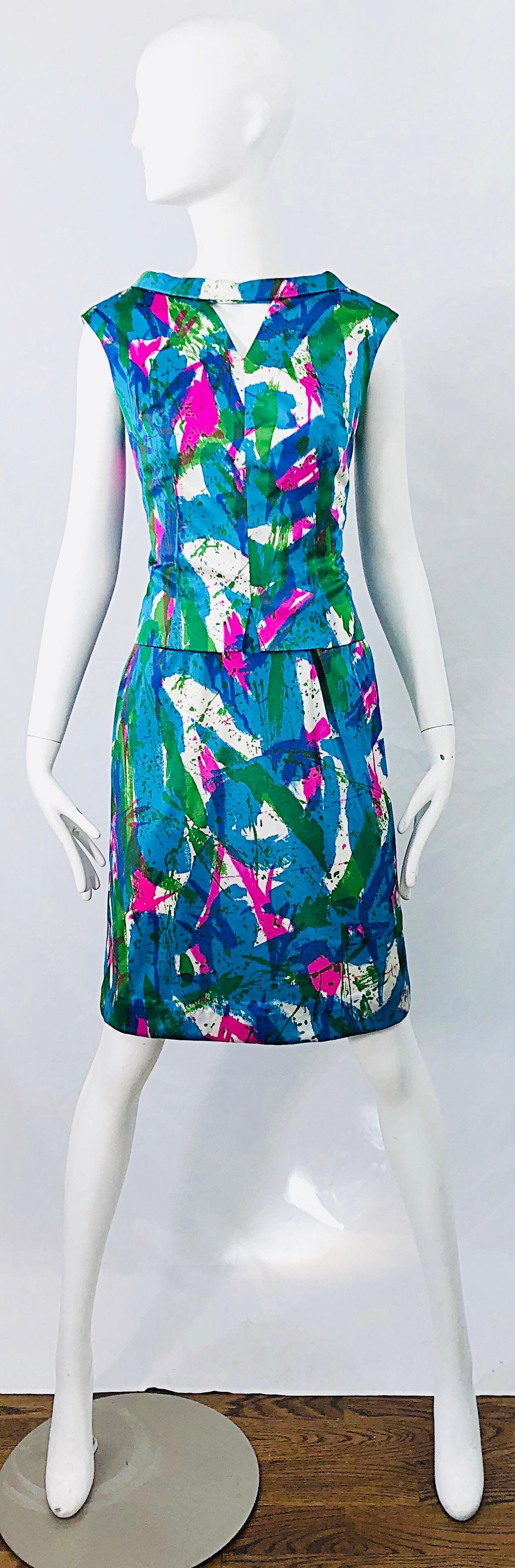 Chic mid 60s vibrant colored abstract print two piece sheath dress and top ! Features vibrant neon colors of pink, blue, turquoise, green and white throughout. Top features center cut-out at top center neck. Dress has a tailored bodice with nipped