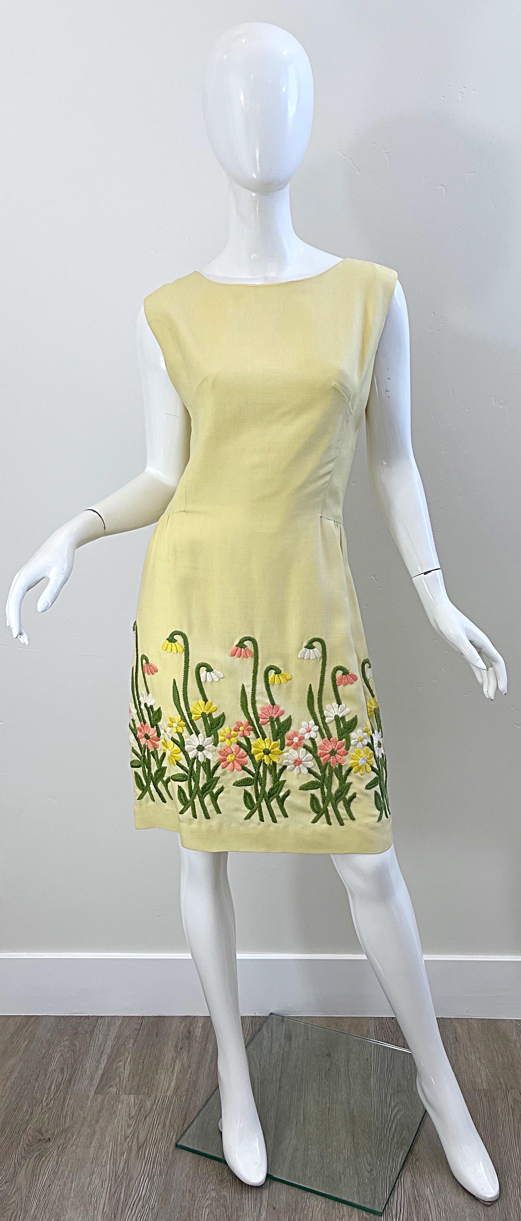 Chic 1960s pale yellow embroidered linen sheath dress ! Features intricate embroidery of flowers and daisies throughout the front and back hem. Fully lined. Hidden metal zipper up the back with hook-and-eye closure. Perfect for any spring /summer