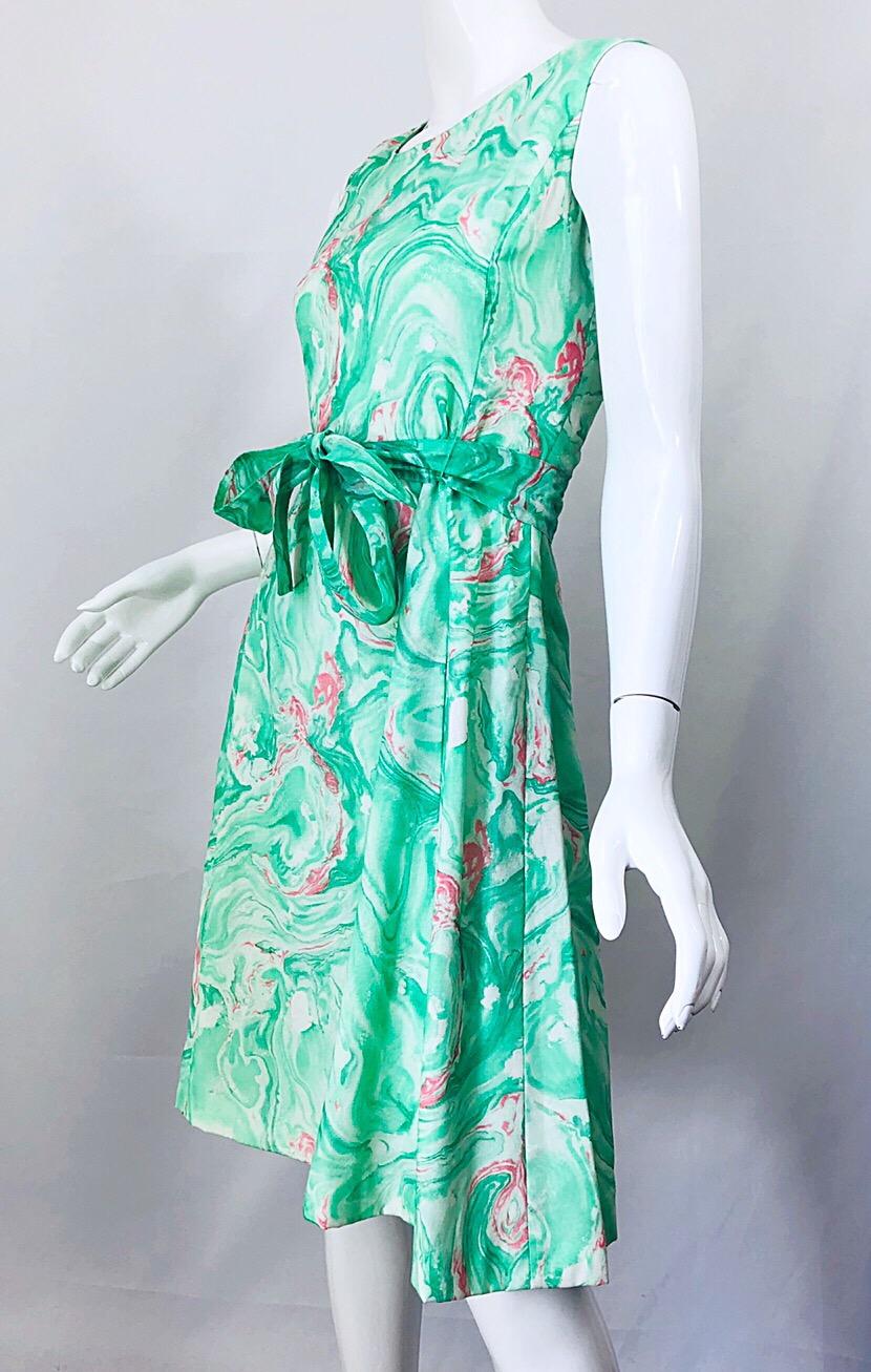Chic 1960s lightweight cotton blend pastel green, pink and white swirl print A-Line dress and cropped jacket suit! Dress features a fitted bodice with a forgiving full skirt. POCKETS at each side of the hips. Belt ties (either the front or back) at