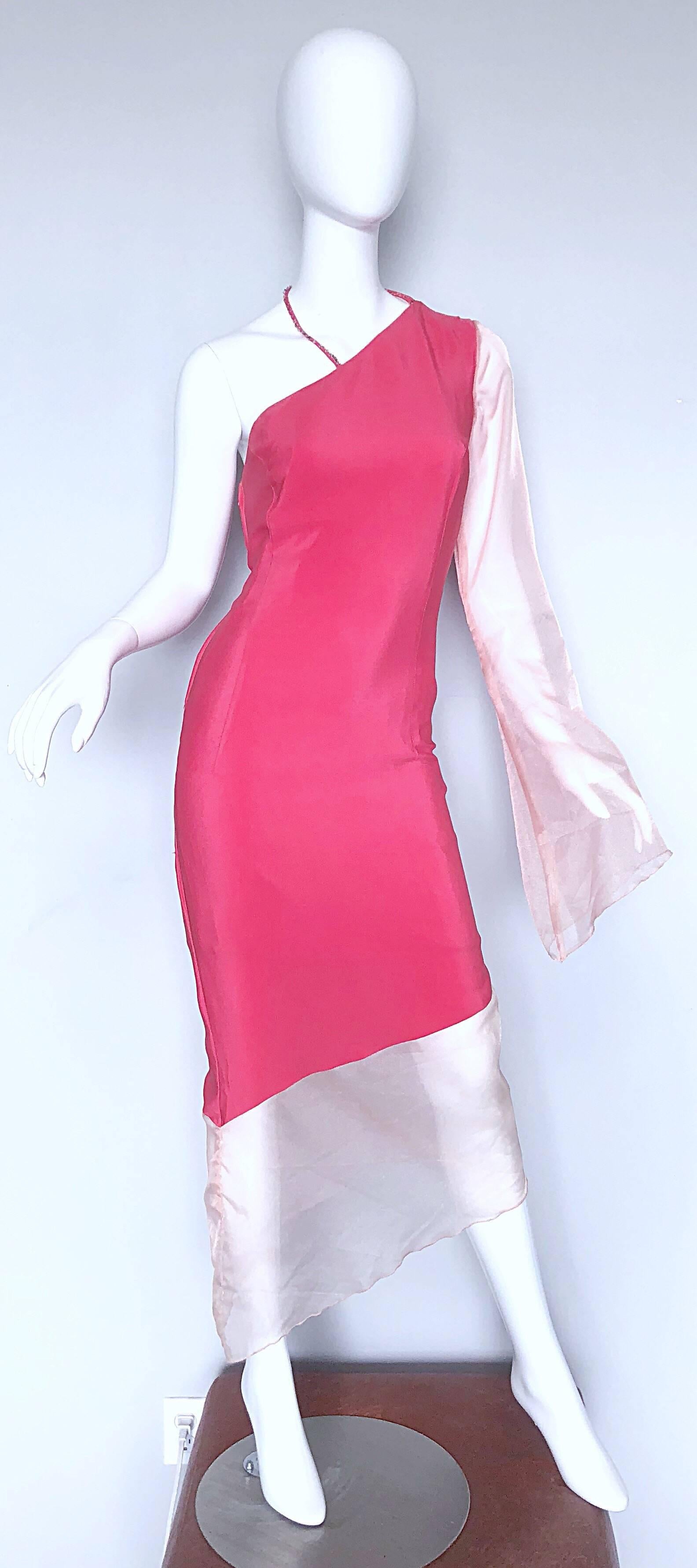 Chic 1960s pink silk one shoulder beaded asymmetrical hem bell sleeve dress! Features a beautifully fitting silhouette that hugs in all the right places. Pale pink organza bell sleeve and hem. Full metal zipper up the side with hook-and-eye closure.