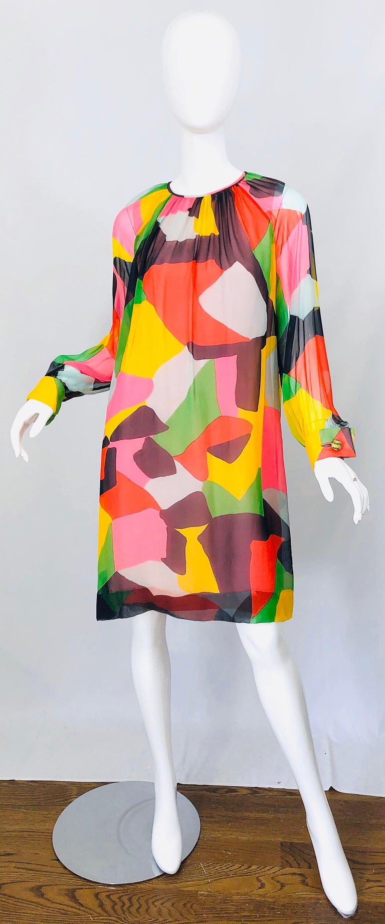 Chic 1960s REMBRANDT by OLE BORDON silk chiffon abstract print dress! Features a fine airy silk chiffon over a light pink silk. Semi sheer full bishop sleeves with gold and green rhinestone encrusted buttons at each sleeve cuff. Hidden metal zipper