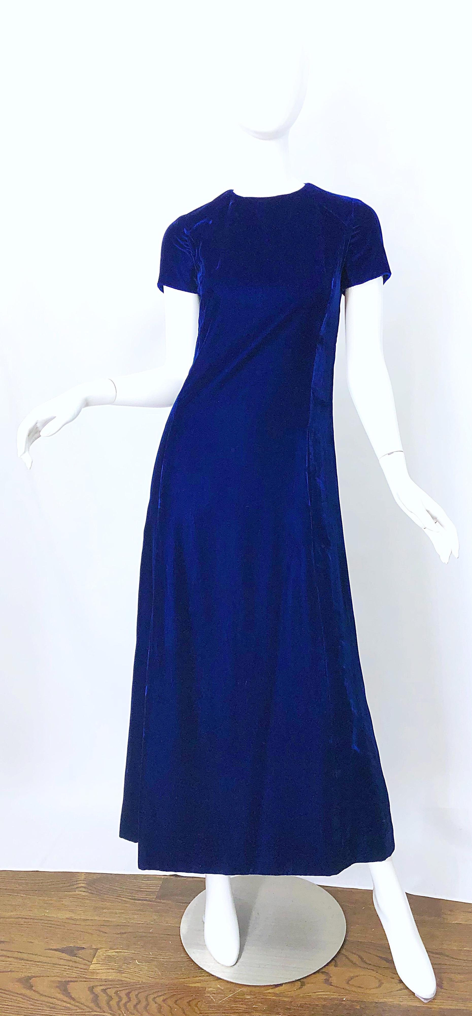 Chic early 70s navy blue silk velvet short sleeve maxi dress! Features a rich vibrant shade of navy blue. Tailored fitted bodice with a forgiving skirt. Full metal zipper up the back with hook-and-eye closure. POCKETS at each side of the waist.